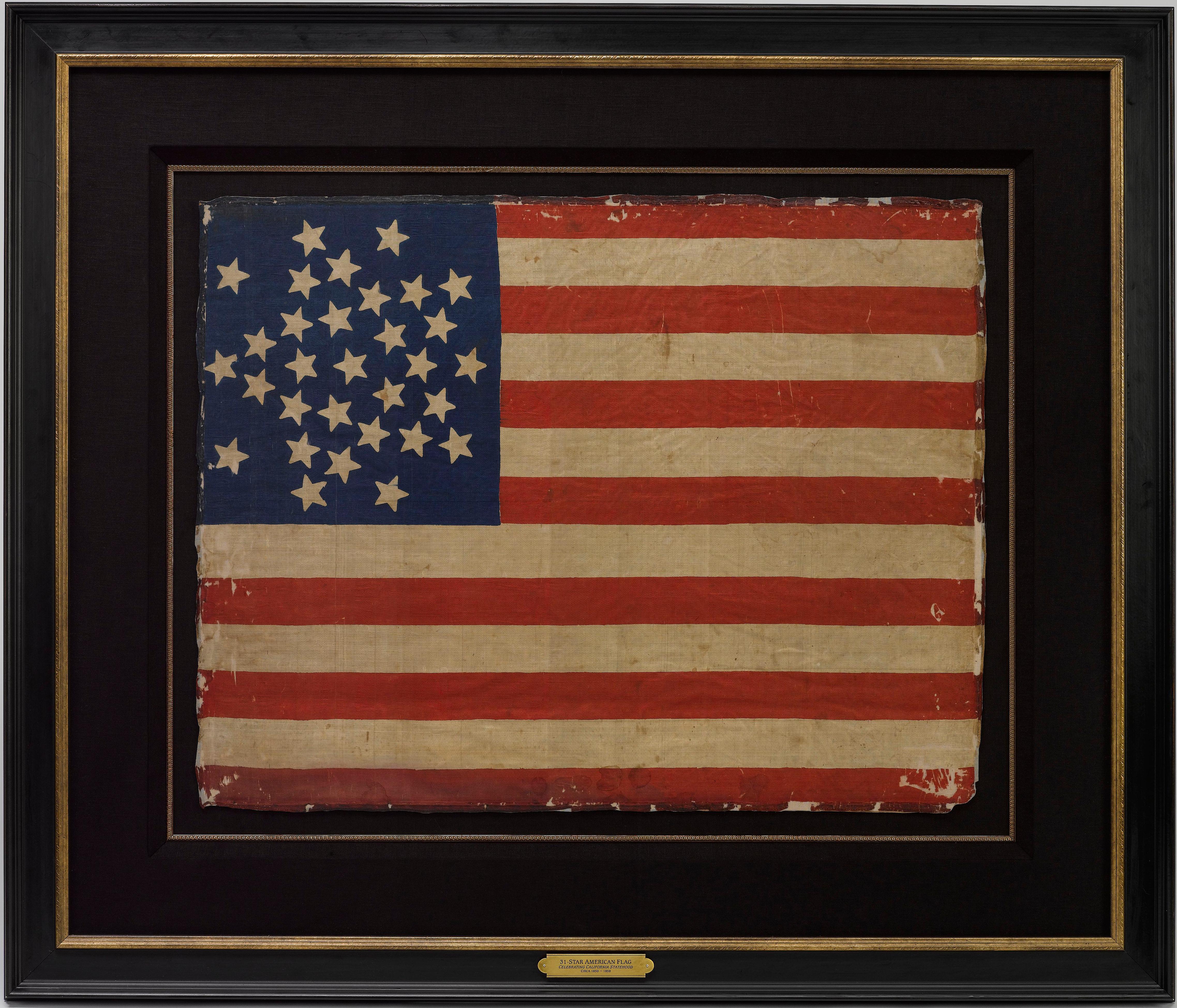 This is a rare 31-star medallion printed American flag, celebrating the addition of California to the Union. The flag is printed on silk and has a spectacular “Great Star” canton pattern. The dark blue canton has 26 white stars, arranged into the