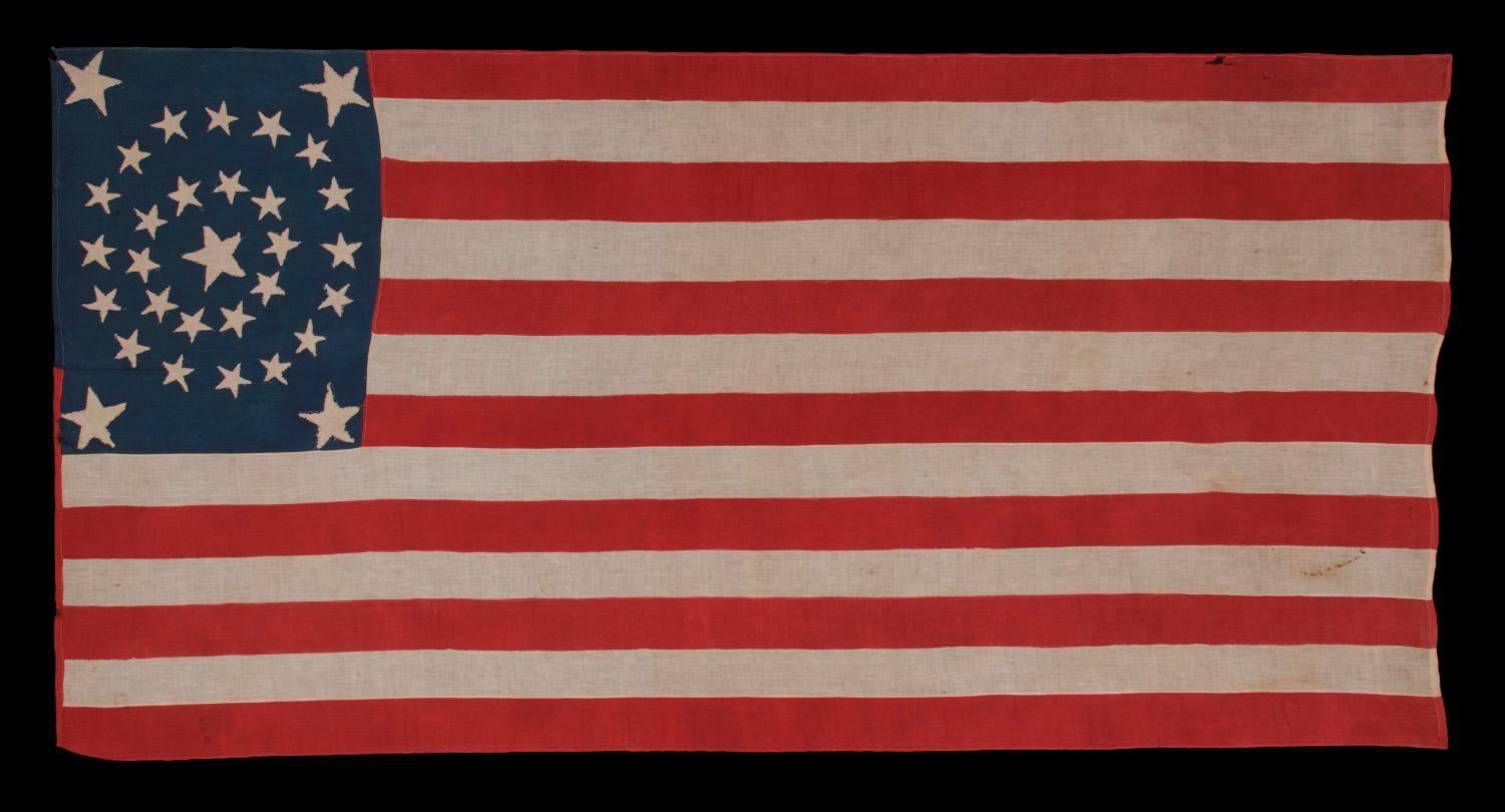 31 STARS IN A MEDALLION PATTERN ON AN ELONGATED, HOMEMADE FLAG WITH A VERTICALLY-ORIENTED CANTON AND EXCEPTIONAL FOLK QUALITIES, PRE-CIVIL WAR, CALIFORNIA STATEHOOD, 1850-1858 

31 star American national flag, constructed of cotton and homemade,