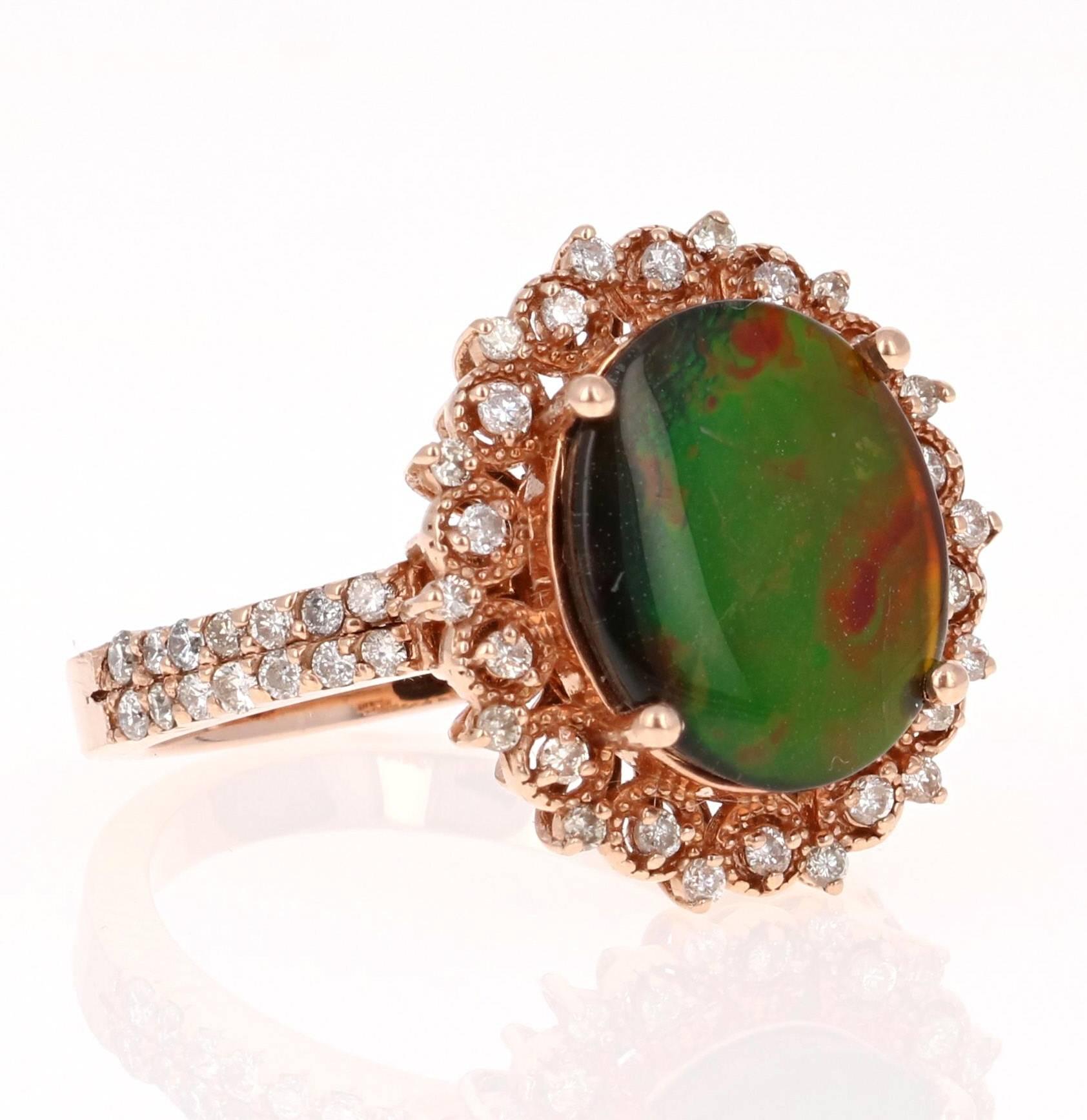 This unique ring has a 2.67 Carat Oval Cut Ammolite in the center of the ring.  Ammolite is an Opal-like organic gemstone that is primarily found in the eastern slopes of the North American Rocky Mountains. The Ammolite has hues of green, blue,