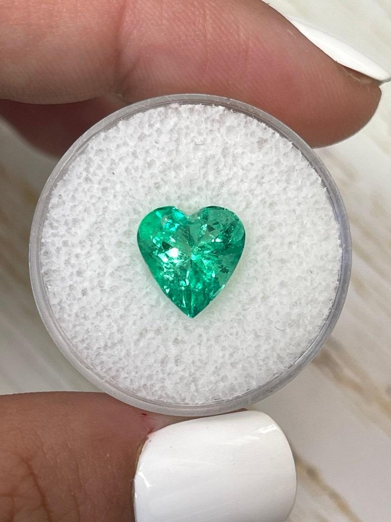 Stone: Emerald
Weight: 3.10 carats
Shape: Heart Cut
Clarity: Transparent
Luster: Excellent/Very Good
Color: Medium Yellowish Green
Measurements: 10.16mm x 9.77mm x 6.55mm
Geographic Origin: Colombia
Treatment: Natural, Oiling

Comments: Due to their