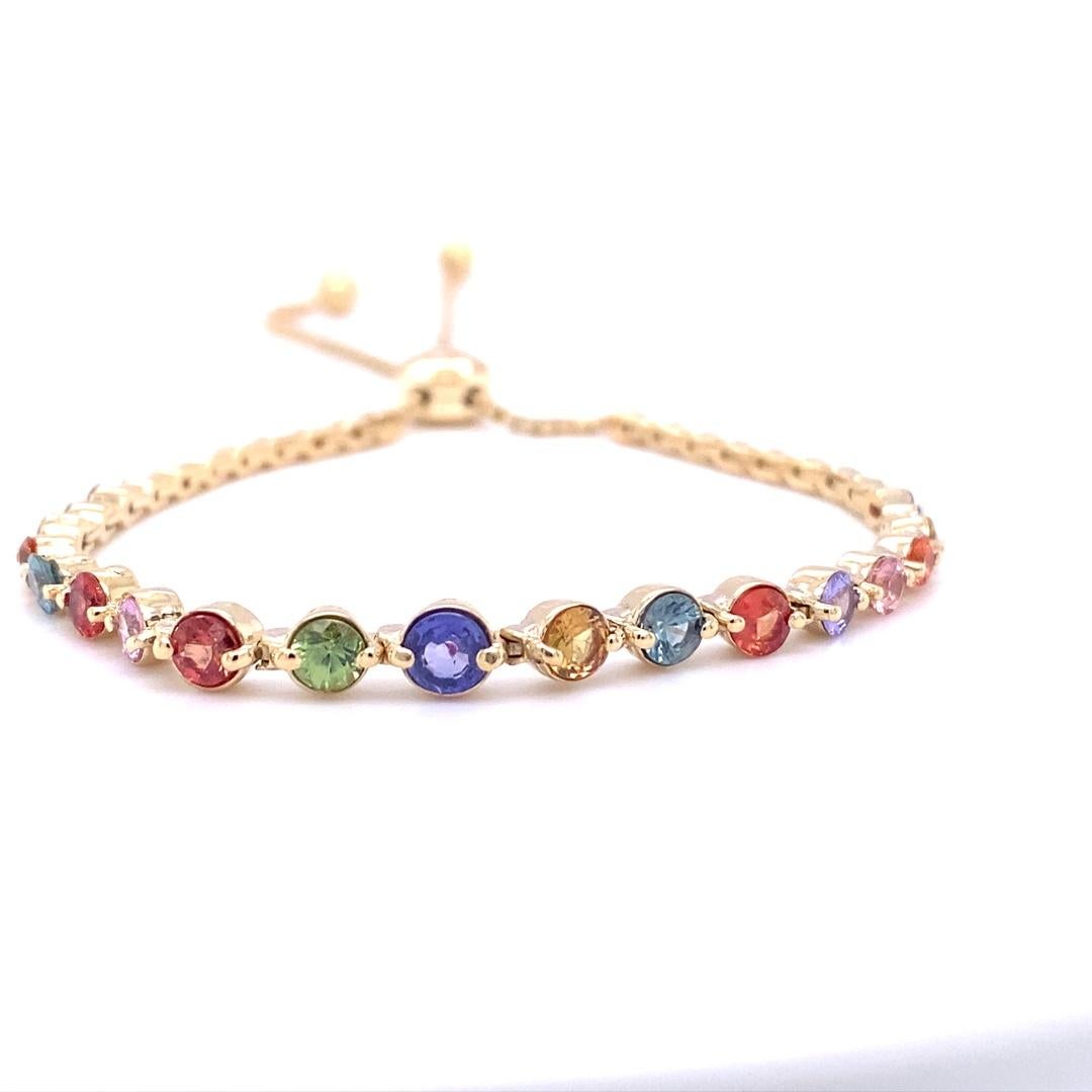 **BEST SELLER**

Dainty, Delicate, and Beautiful. 
A 14K Yellow Gold Multi Color Sapphire and Diamond Bracelet with an adjustable design for the perfect fit!

There are 22 Round Cut Multicolored Sapphires that weigh 2.79 Carats and 16 Round Cut