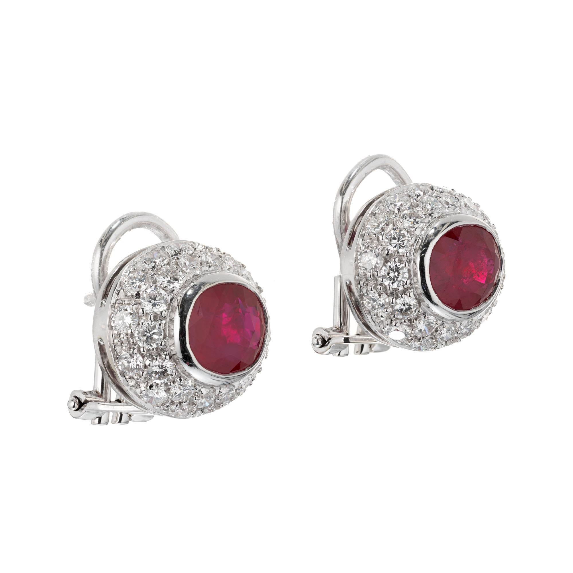 Oval domed ruby and diamond pave halo 18k white gold clip post earrings. 

2 oval 8 x 6mm Rubies approx. total weight 3.10cts. 
60 round diamonds approx. total weight 2.00cts, F to G, VS. 
Stamped:750 WG. 
9.0 grams.
Length: 15mm. 
Width:
