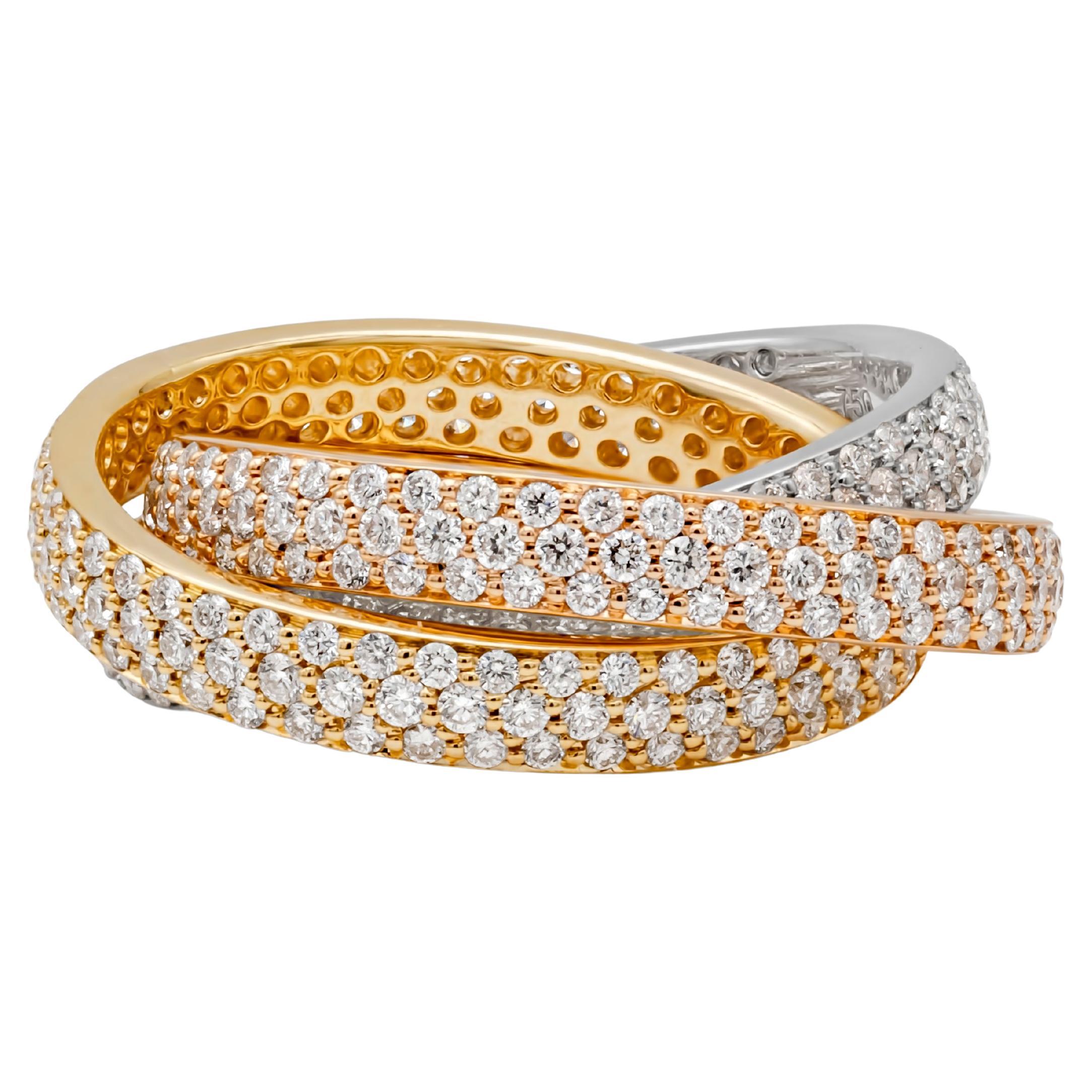 This gorgeous and stunning infinity rolling fashion ring features 18k white gold, yellow gold and rose gold pave eternity bands interlocked and accented with 414 brilliant round cut diamonds weighing 3.10 carats total, F-G color and VS-SI in