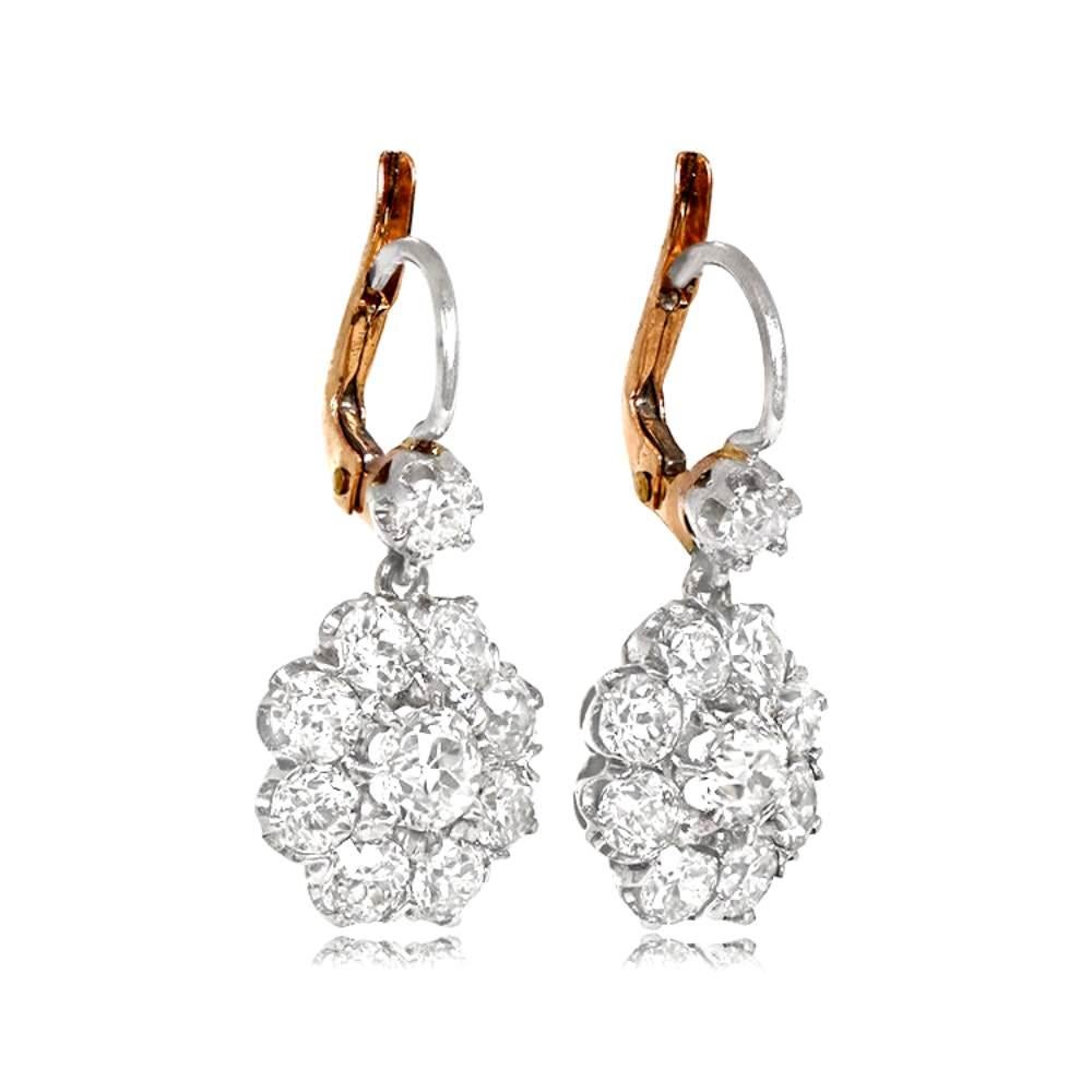 Behold these exquisite platinum and diamond drop earrings, a true embodiment of elegance. Their enchanting design showcases a captivating cluster of old European cut diamonds, delicately cradled in secure prongs at the bottom of each earring.