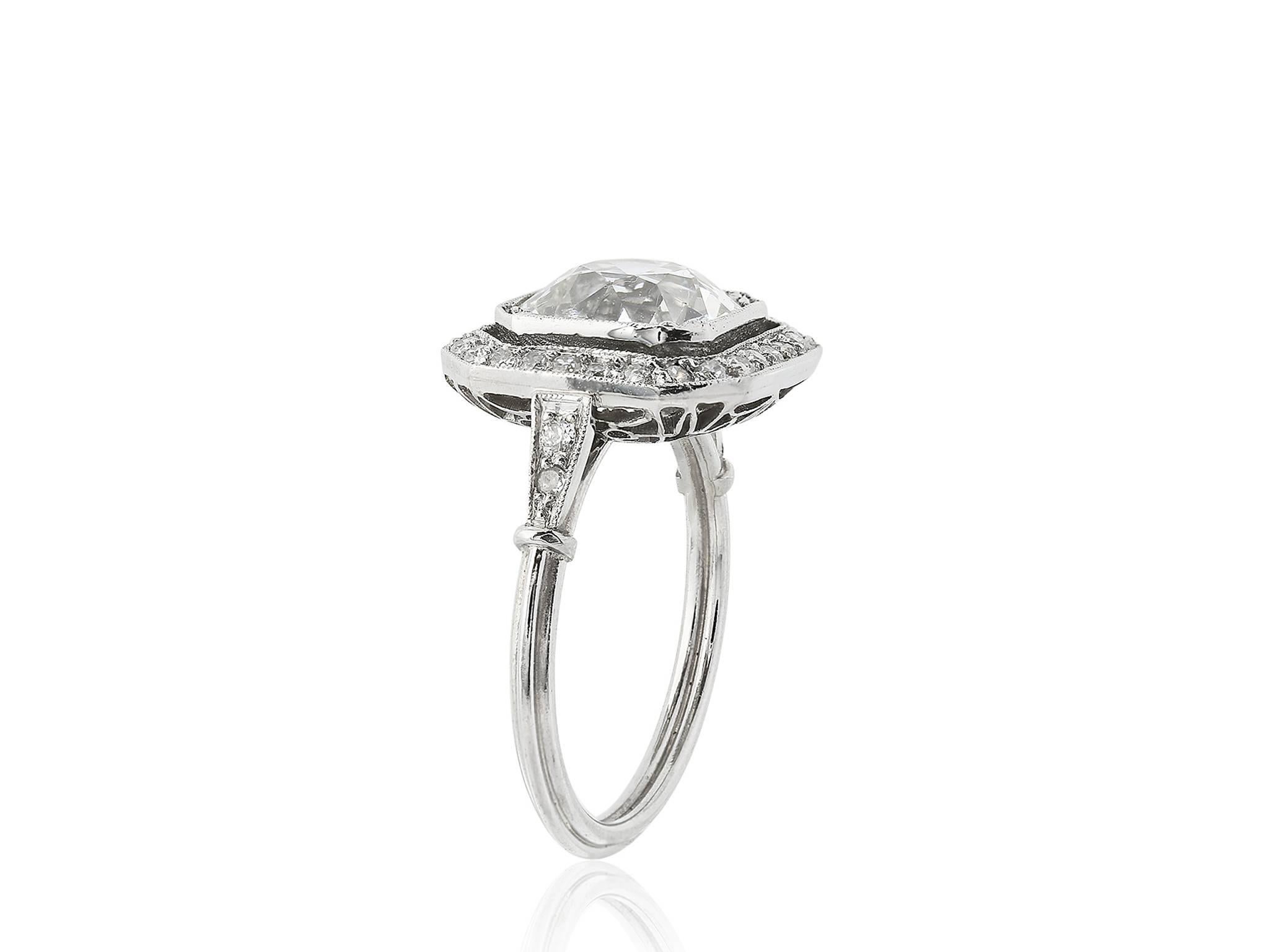 Platinum vintage style ring consisting of 1 Old European cut diamond weighing approximately 3.10 carats having a color and clarity of I/SI1 respectively, set with Old European cut diamonds surrounding the center stone and going down the shoulders