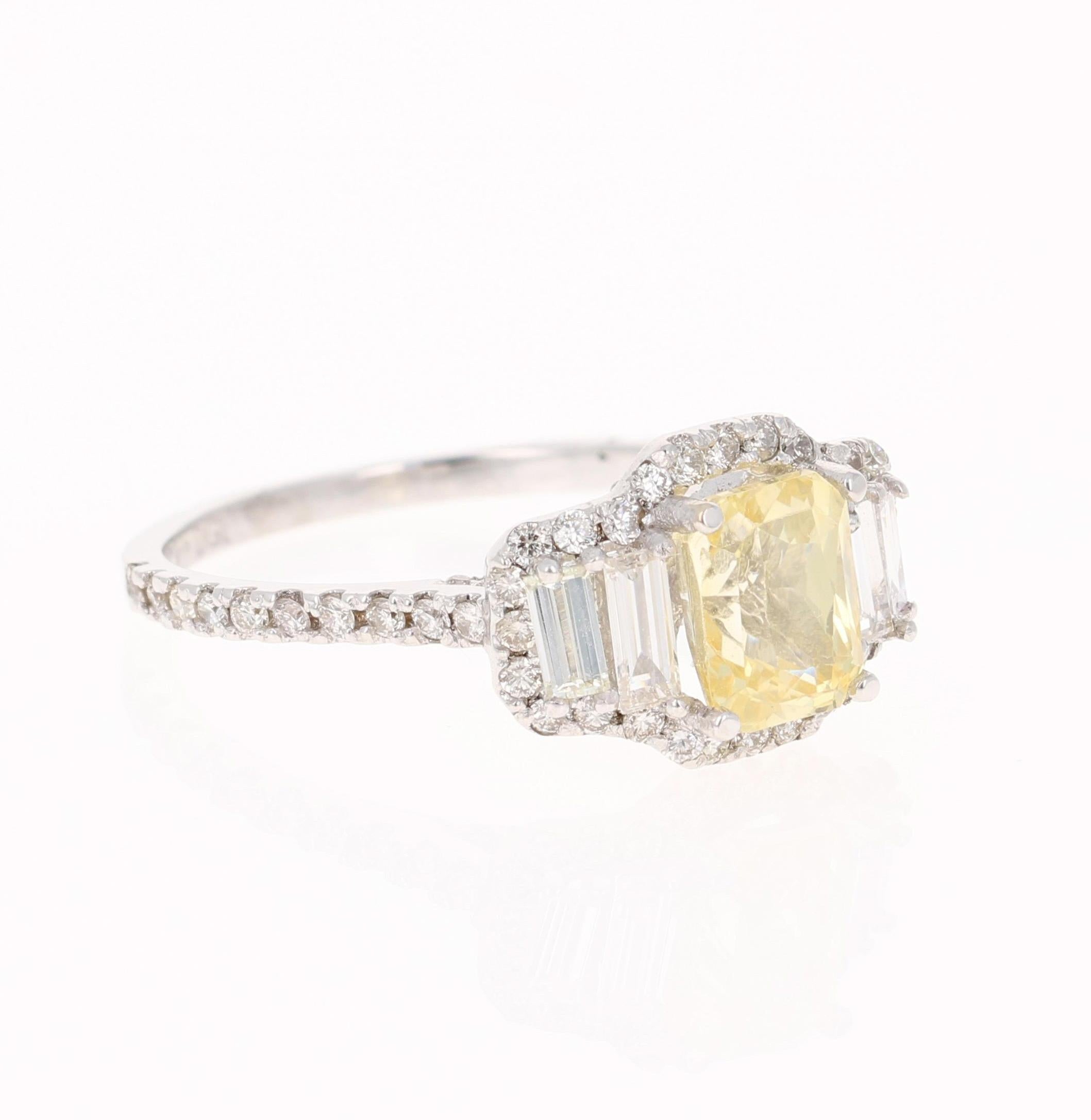 A gorgeous Yellow Sapphire Ring in a classic halo setting and resembling a three-stone ring! This gorgeous Emerald Cut Yellow Sapphire is a natural, NO heat Sapphire that weighs 2.08 Carats.  
It has 86 Round Cut Diamonds that weigh 0.65 carats