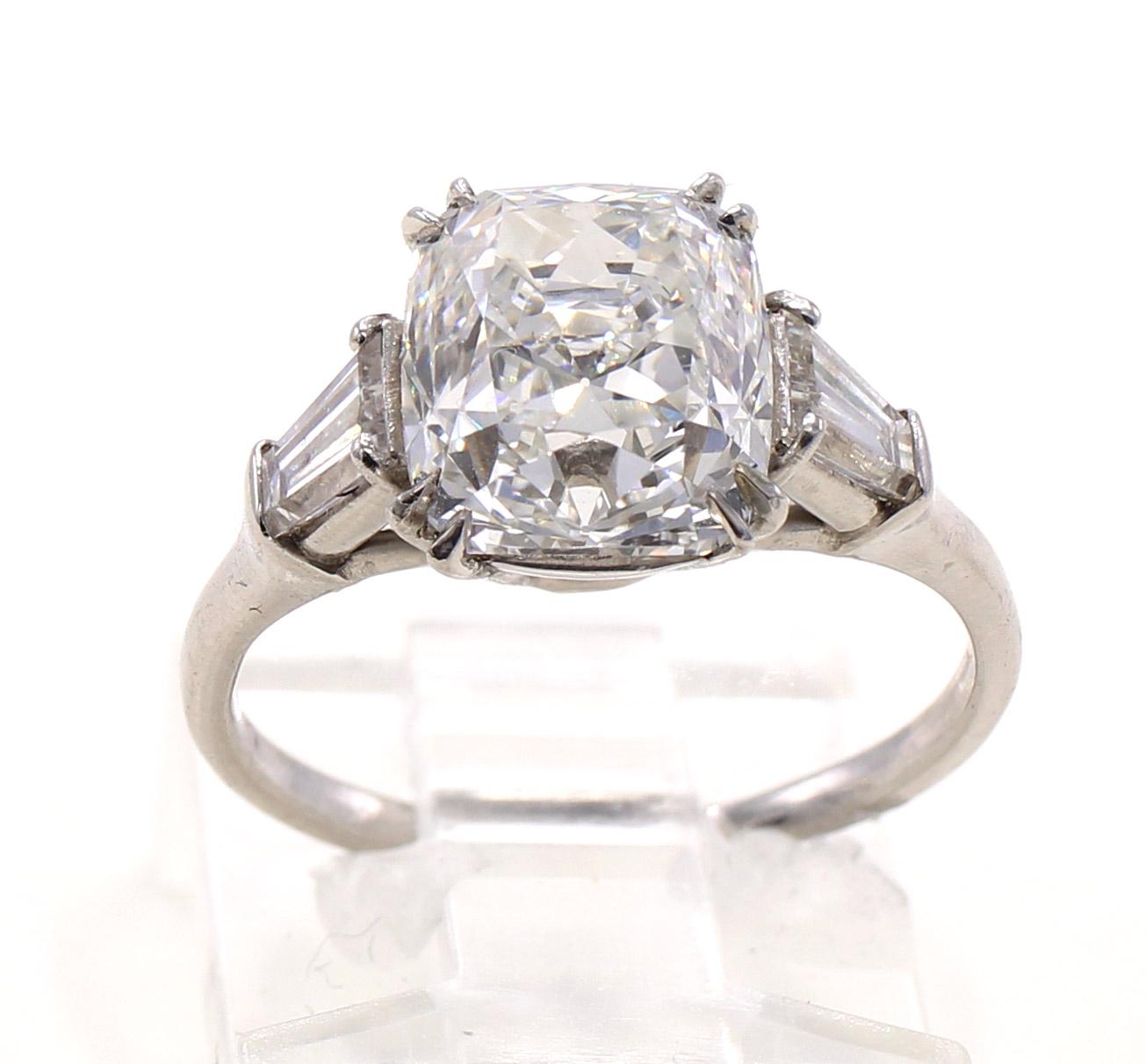 A gorgeous antique cut lively antique cut cushion brilliant weighing 3.11 carats is the centerpiece of this platinum baguette diamond engagement ring. This diamond is full of fire and sparkle due to it's amazing cut and faceting. The true antique