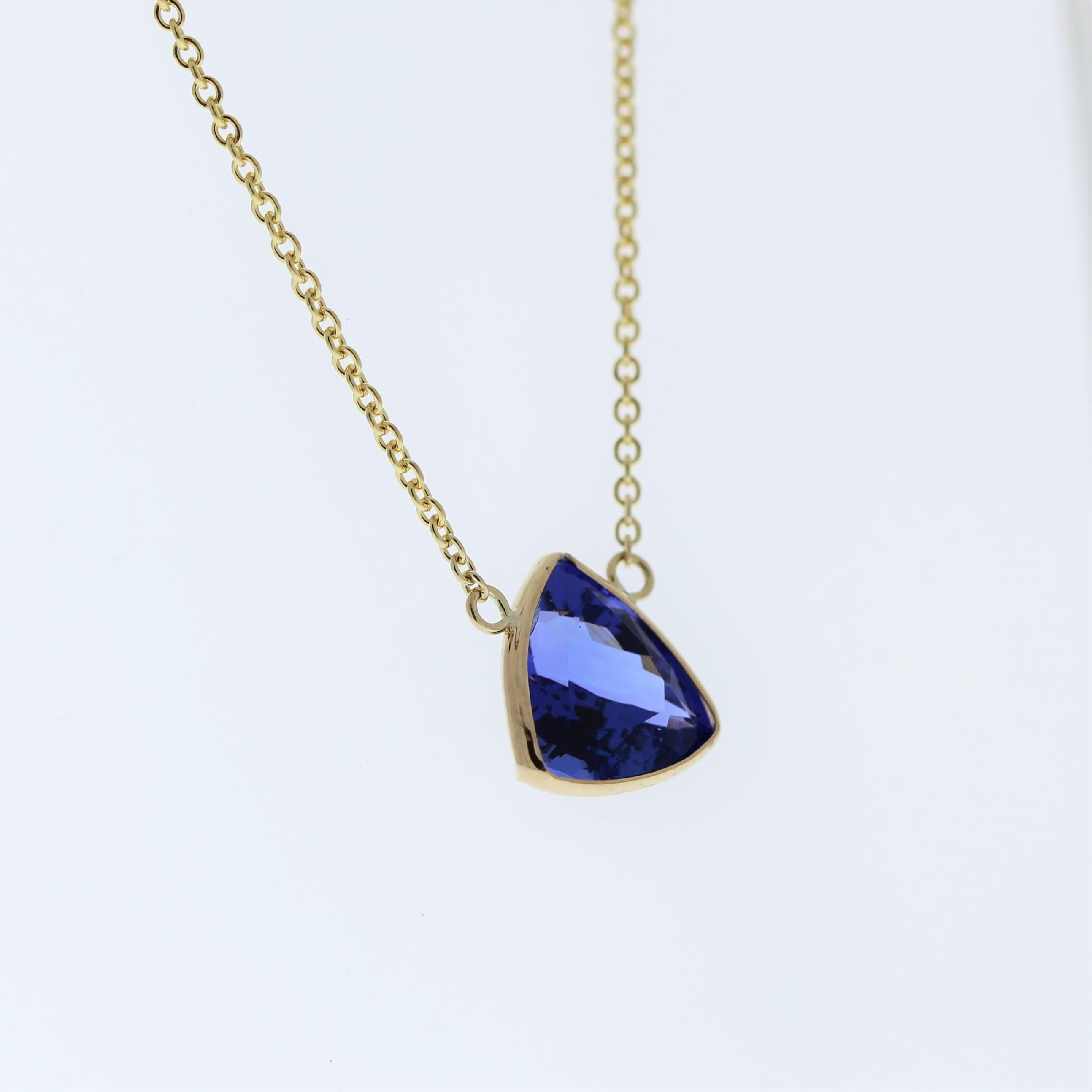 The necklace features a 3.11-carat trilliant-cut tanzanite set in a 14 karat yellow gold pendant or setting. The trilliant cut and the captivating blue-violet color of the tanzanite against the yellow gold setting are likely to create an elegant and