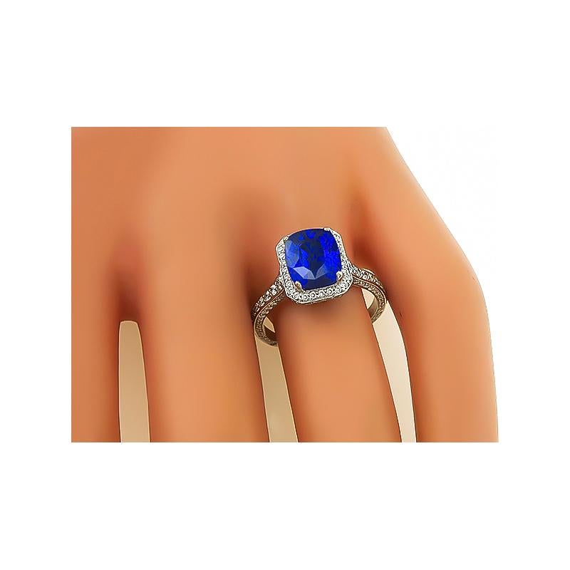 This is a fabulous 14k white gold engagement ring. The ring is centered with a lovely cushion cut Ceylon sapphire that weighs approximately 3.11ct. The sapphire is accentuated by sparkling round cut diamonds that weigh approximately 0.75ct. The
