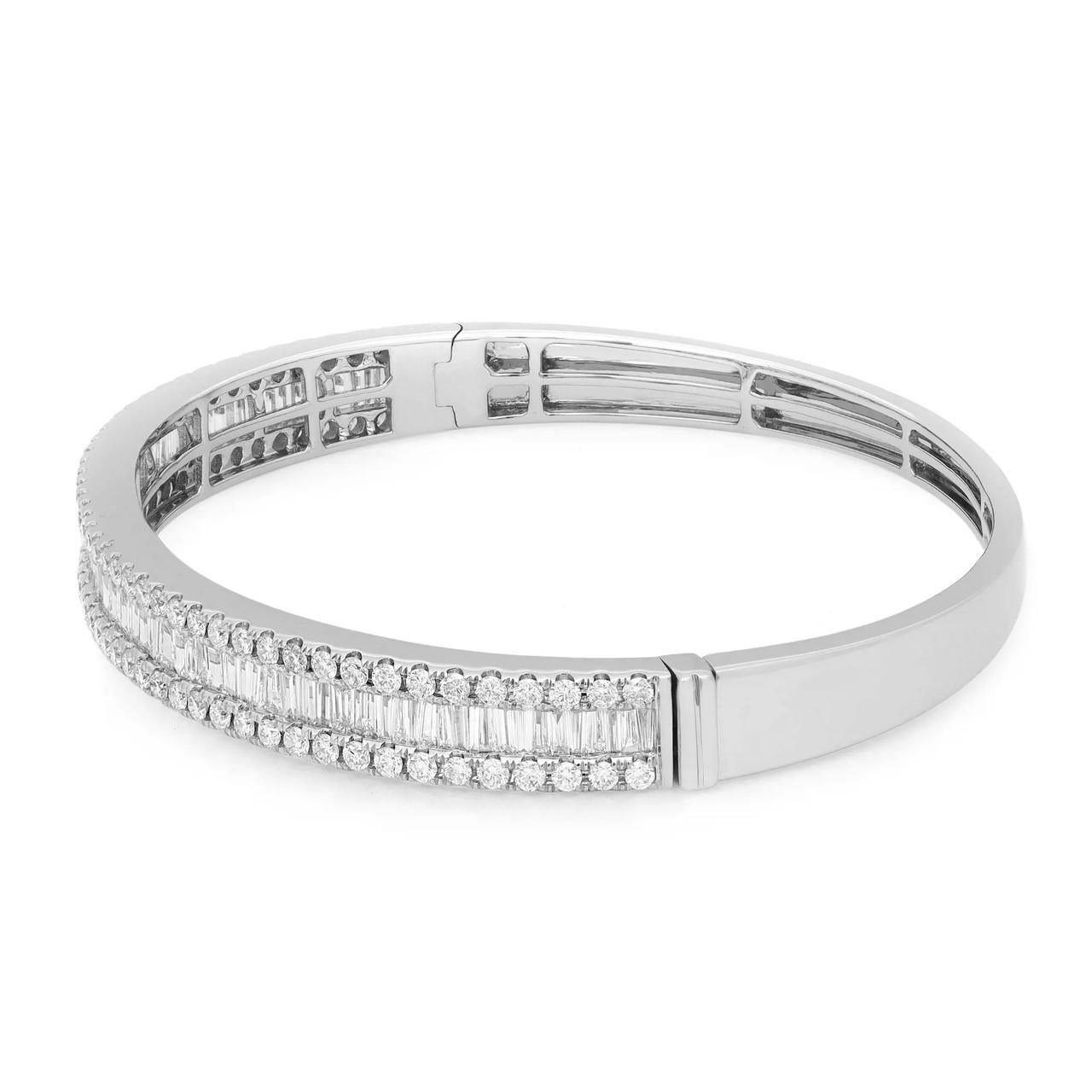 Adorn your wrist with this exquisite bangle bracelet that exudes timeless beauty. Crafted from gleaming 18K white gold, it features a dazzling row of diamonds. The center row showcases channel-set baguette-cut diamonds, while round-cut diamonds