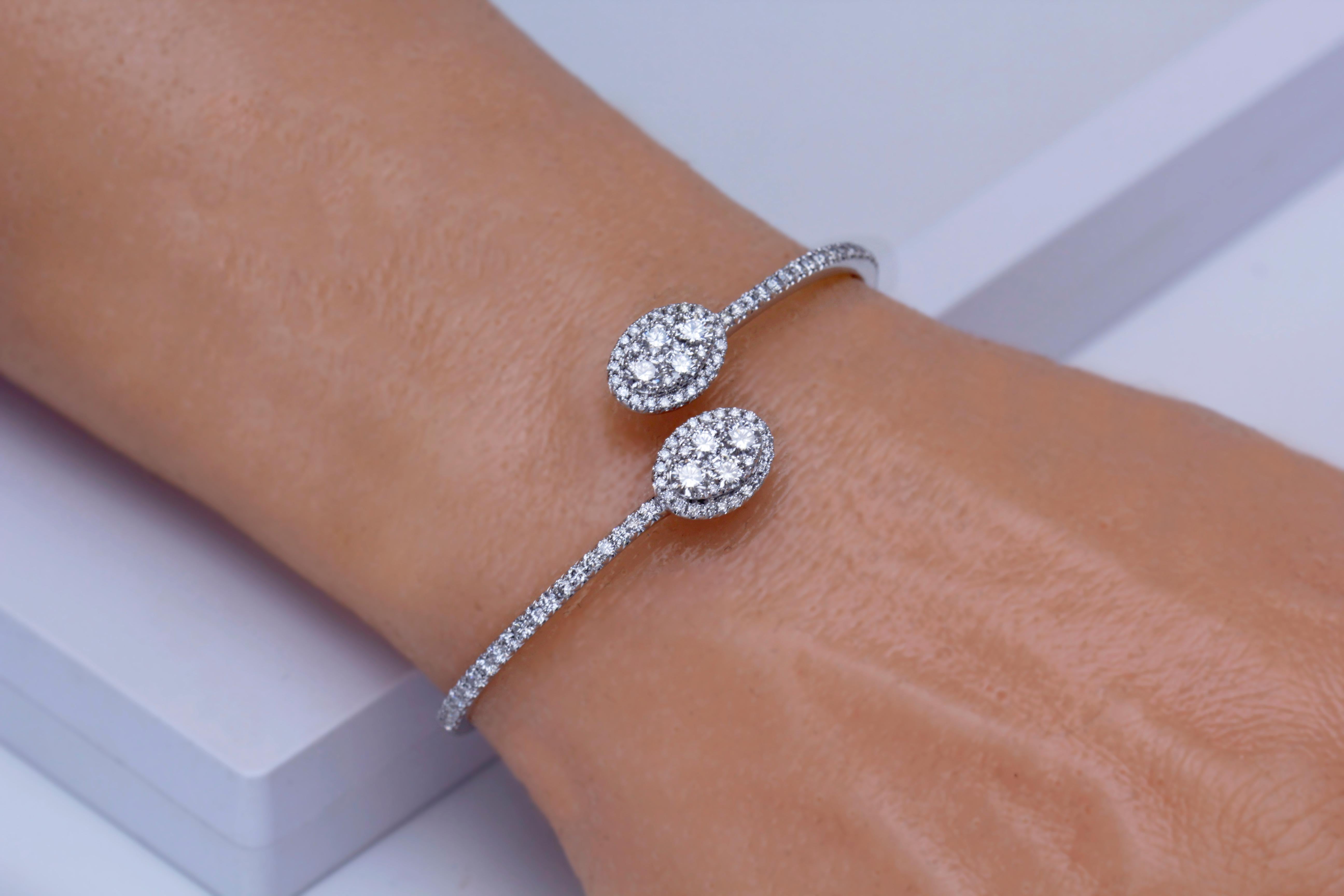Make a bold and beautiful statement with this Bangle Bracelet, adorned with 3.12 carats of natural diamonds. It's more than just jewelry; it's an expression of your impeccable taste and a symbol of the extraordinary moments in life. Elevate your