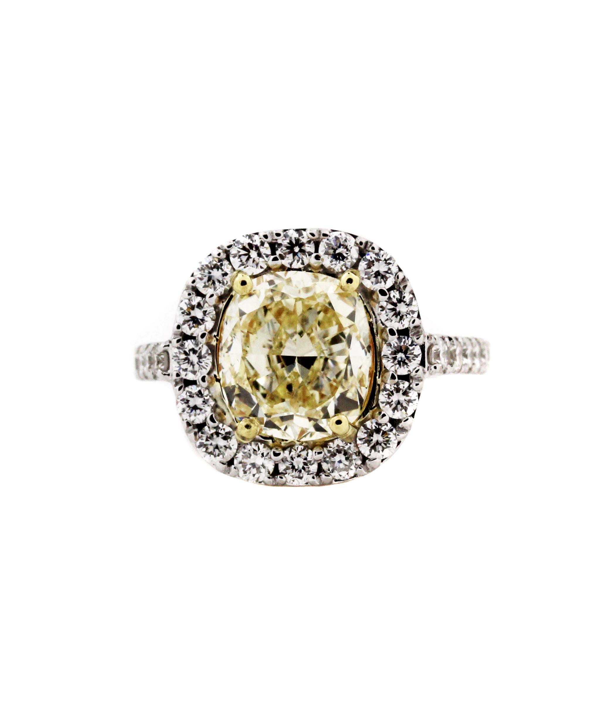 18K White Gold Ring with 3.12 carat Fancy Light Yellow Diamond 

Fancy Light Yellow Diamond, Cushion-cut, SI1, 3.12 carat

1.70 carat G color, VS clarity white diamonds all throughout ring

Size 6.5. Sizable