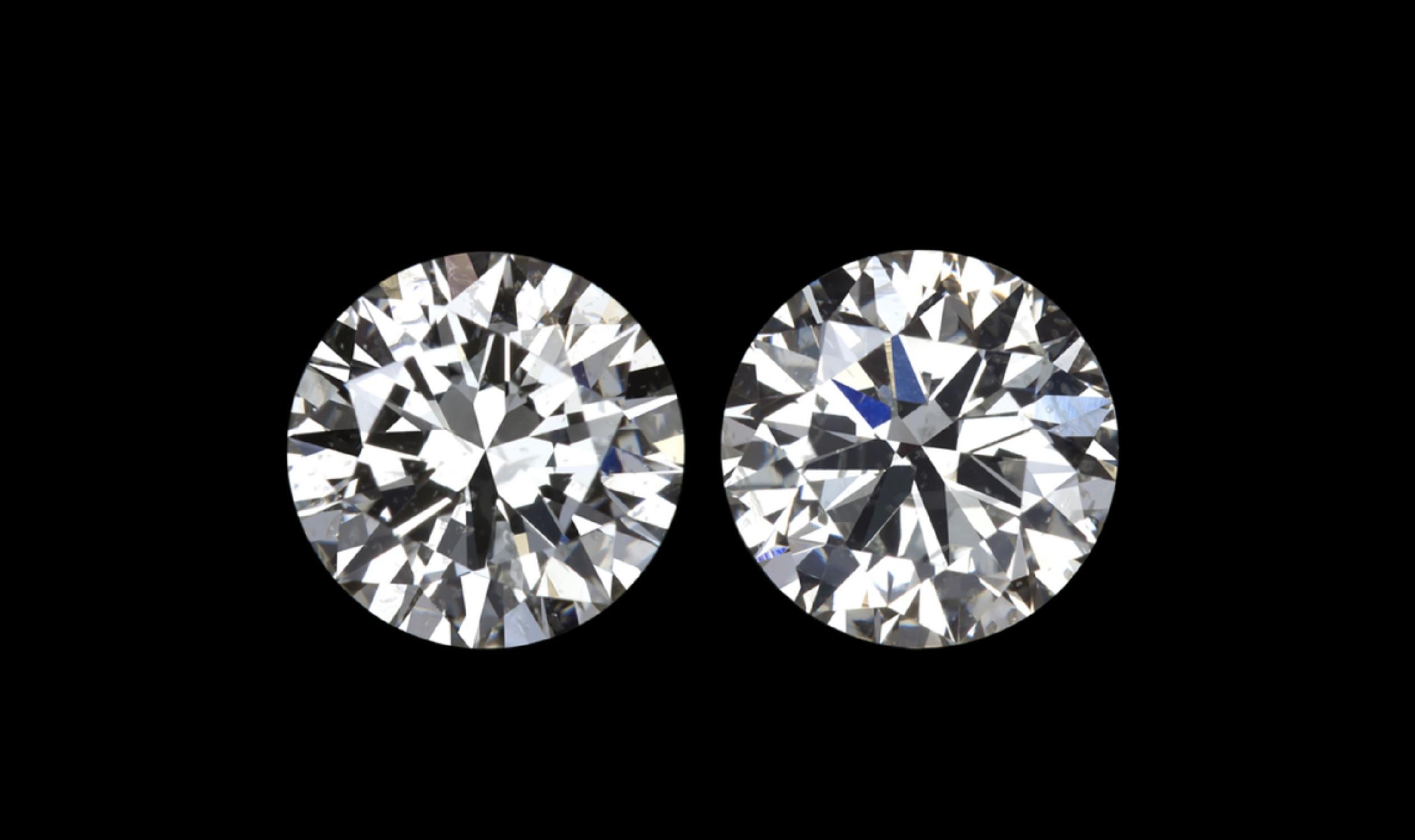 This diamond studs are gorgeous and very large! they are together approx. 3.50 carats 
F/G Color
SI3/I2  but inclusions hide very well and on the ear they appear eye clean

