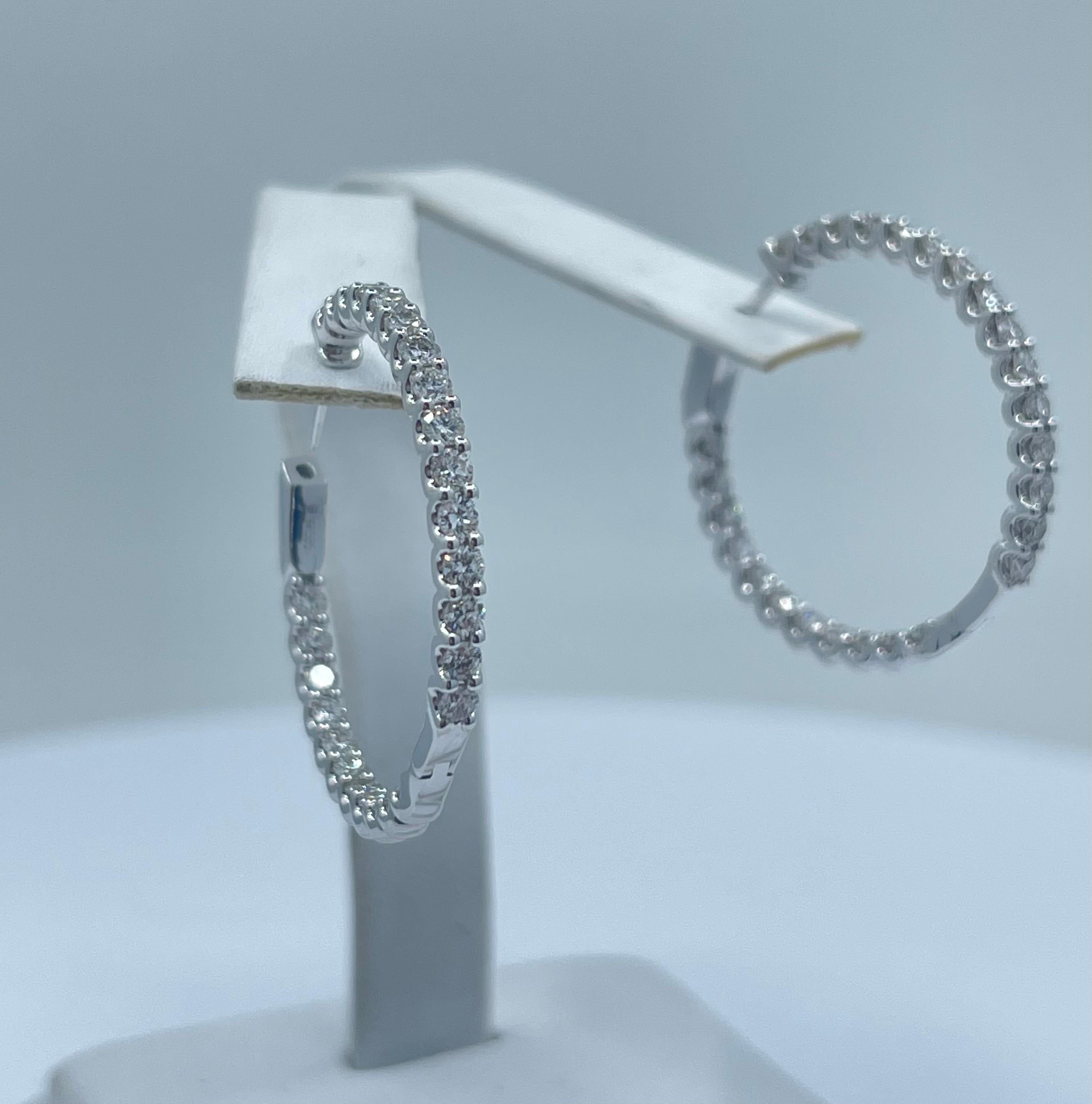 The epitome of understated elegance, these earrings feature 26 sparking round brilliant white diamonds in each earring and are “U” and prong set in 14 karat white gold, with all the diamonds facing forward.  So wearable they will become your