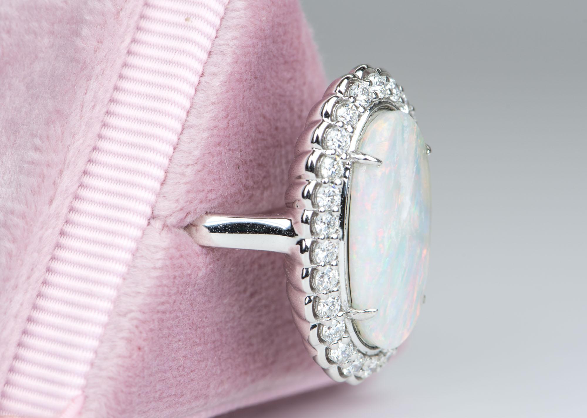 ♥  Solid 14K white gold ring set with an elongated solid Australian opal in the center, flanked by diamonds in a scalloped halo design
 ♥ This Australian opal is full of rainbow flashes like fire red, orange, yellow, blue and green. 
 ♥  The overall
