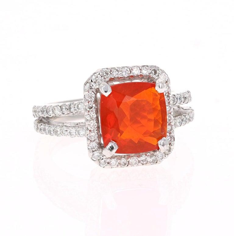 This ring has a Cushion Cut 2.27 carat Fire Opal in the center of the ring and is surrounded by a halo of 78 Round Cut Diamonds that weigh a total of 0.86 carat (Clarity:  VS2, Color: F).  The total carat weight of the ring is 3.13 carats.  
The