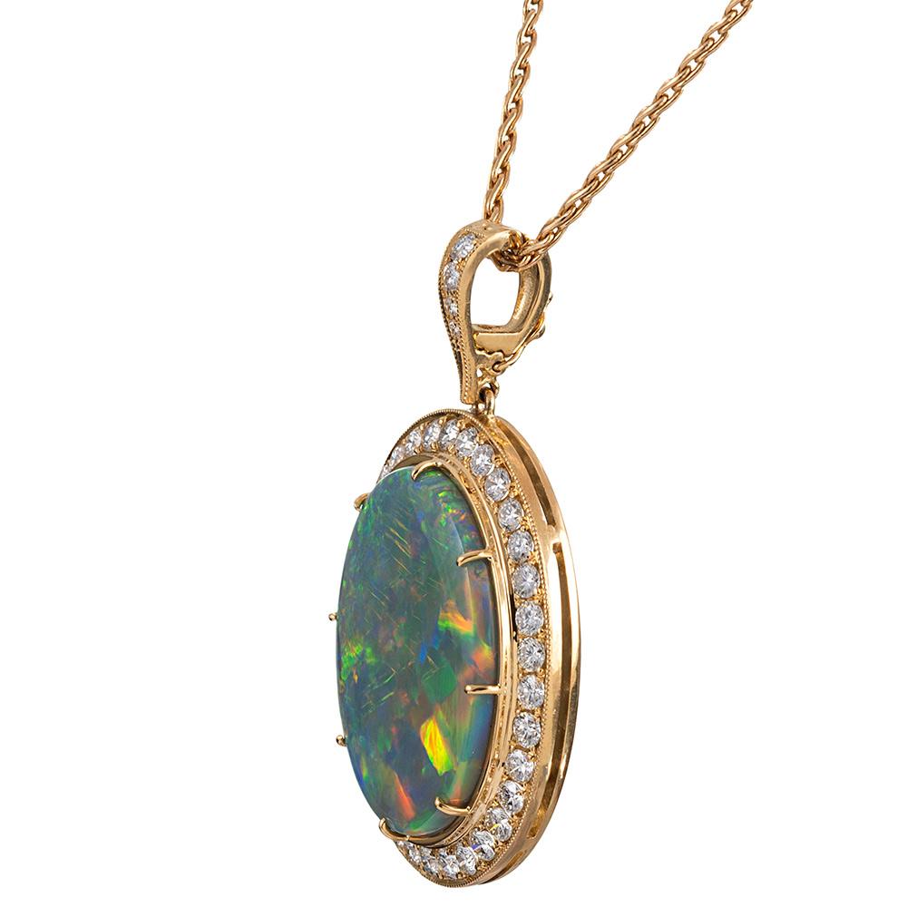 A classically styled and important opal pendant that will remain fashionable forever, the piece is set with an impressive 31.30 carat oval opal. The stone is attributed to the lightning ridge opal mine and exhibits strong flashes of color,