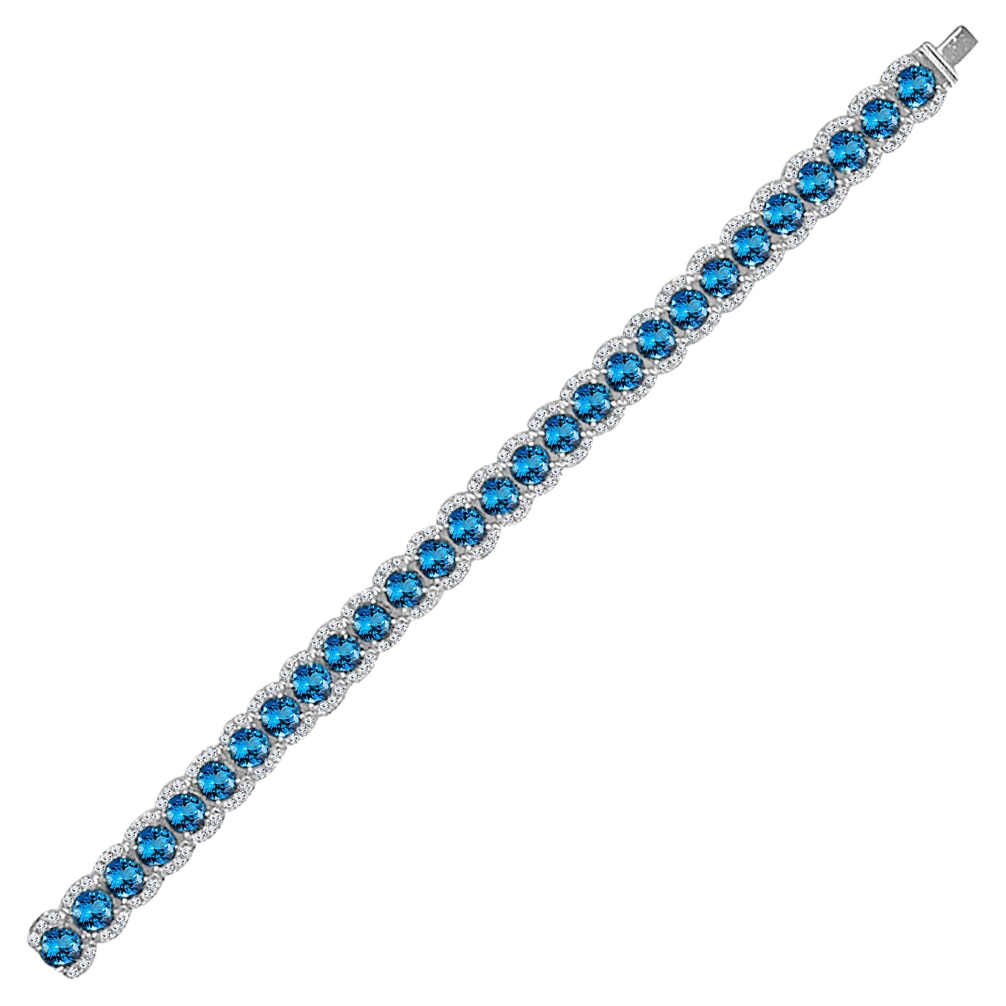 Rehaussez votre look et embrassez la beauté intemporelle avec ce superbe bracelet, orné de 28 pierres précieuses Topaze Bleue Step Cut, pesant chacune 3,10 carats, et gracieusement accentué par des diamants naturels ronds brillants. Fabriqué avec