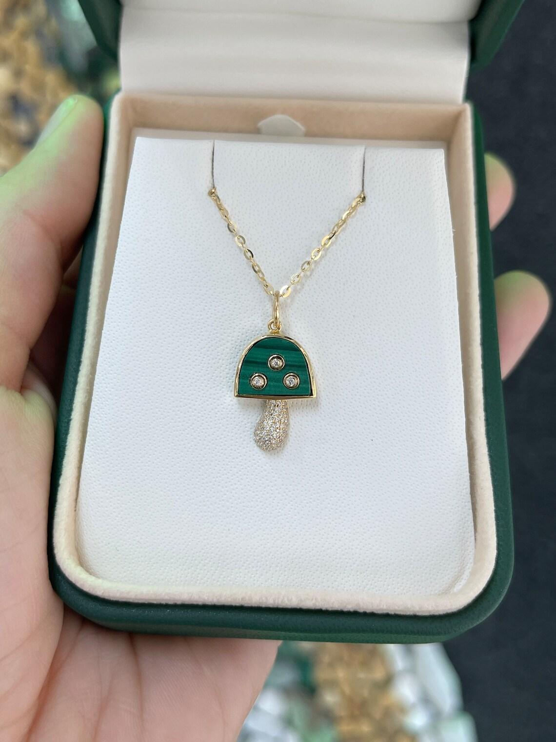 Introducing our Mini Mushroom Pendant/Charm, a petite masterpiece that captures the essence of nature's beauty in a compact design. The charming mushroom head, adorned with 2.90 carats of bezel-set malachite, is accented by a trio of petite natural
