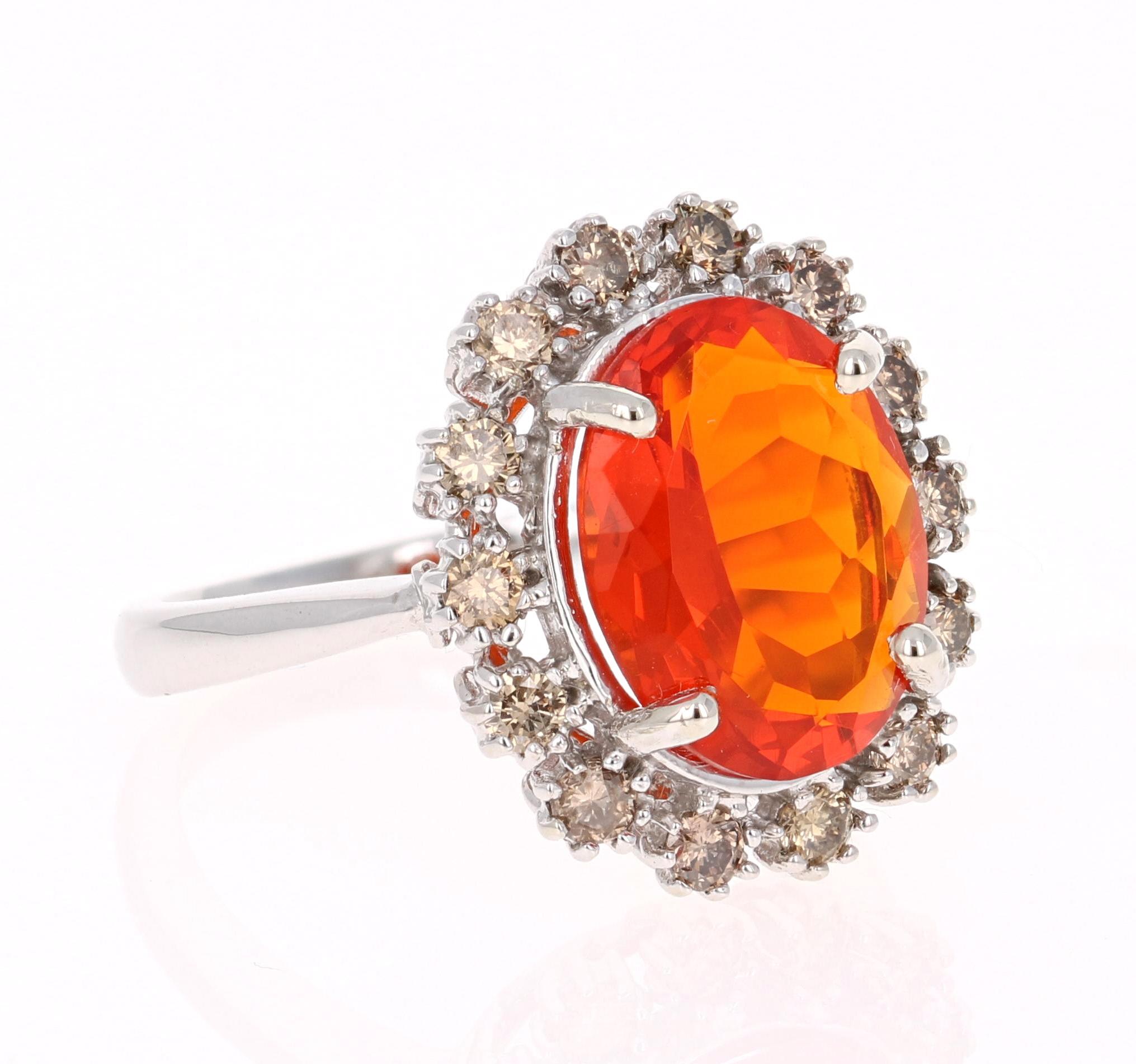 This strong and sharp Fire Opal ring will look like sunshine on your hand! 

It has a blazing orange Oval Cut Fire Opal that weighs 2.57 Carats and is surrounded by 14 Round Cut Champagne Colored Diamonds that are natural and weigh 0.57 Carats. 

It