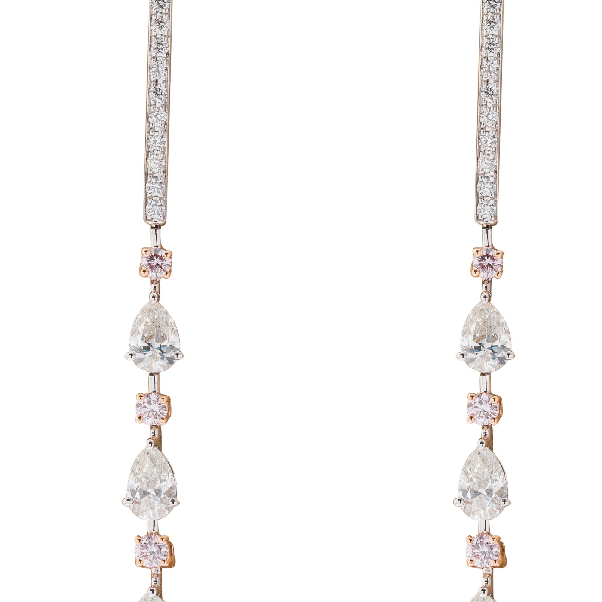 Stunning 18 karat white and rose gold drop earrings consisting of 10 pear shaped diamonds
weighing 3.14 carats, set with 10 round pink diamonds weighing .55 carats and
full cut diamonds weighing .22 carats.