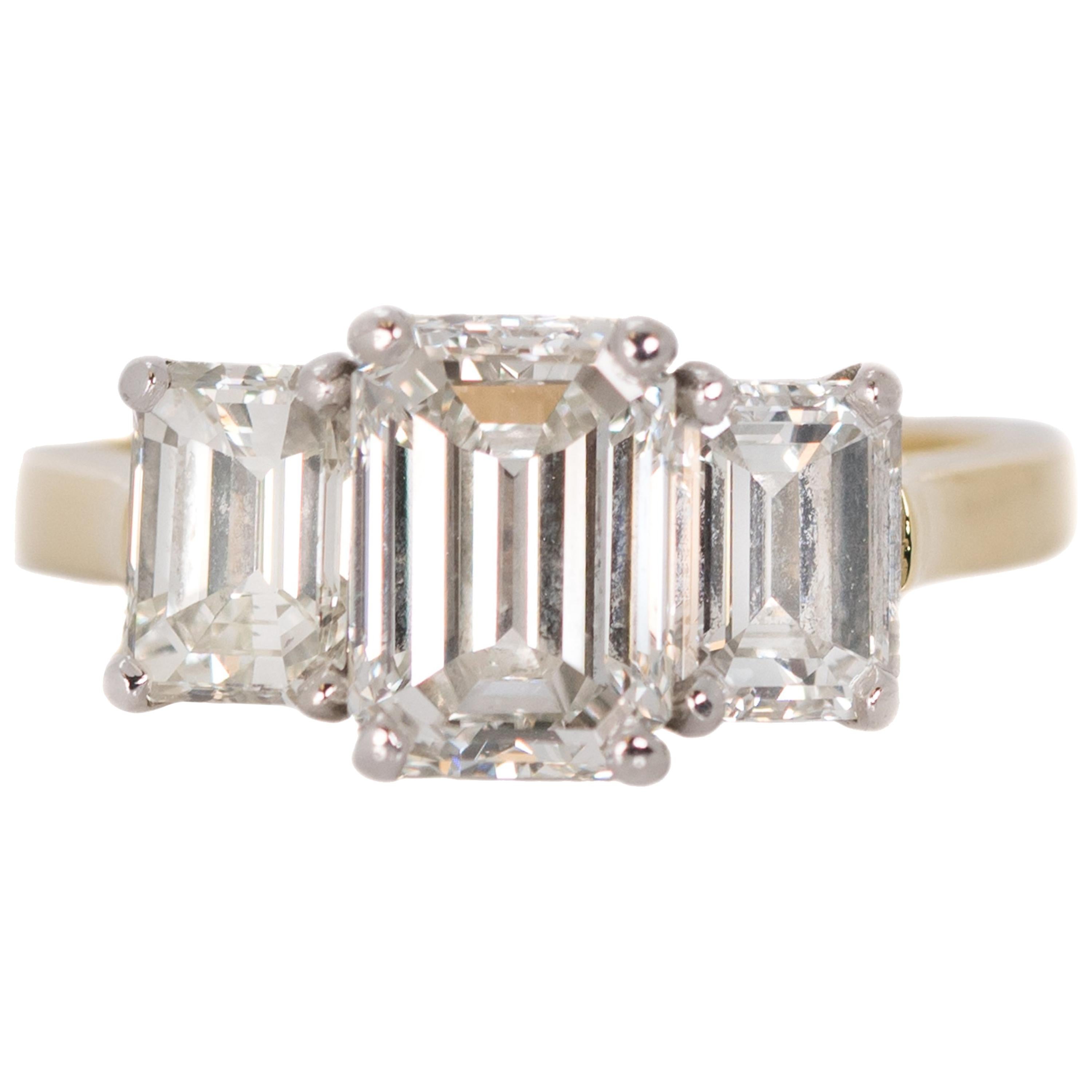 3.14 Carat Total Diamond, Platinum, 18 Karat Gold Three-Stone Emerald Cut Ring
