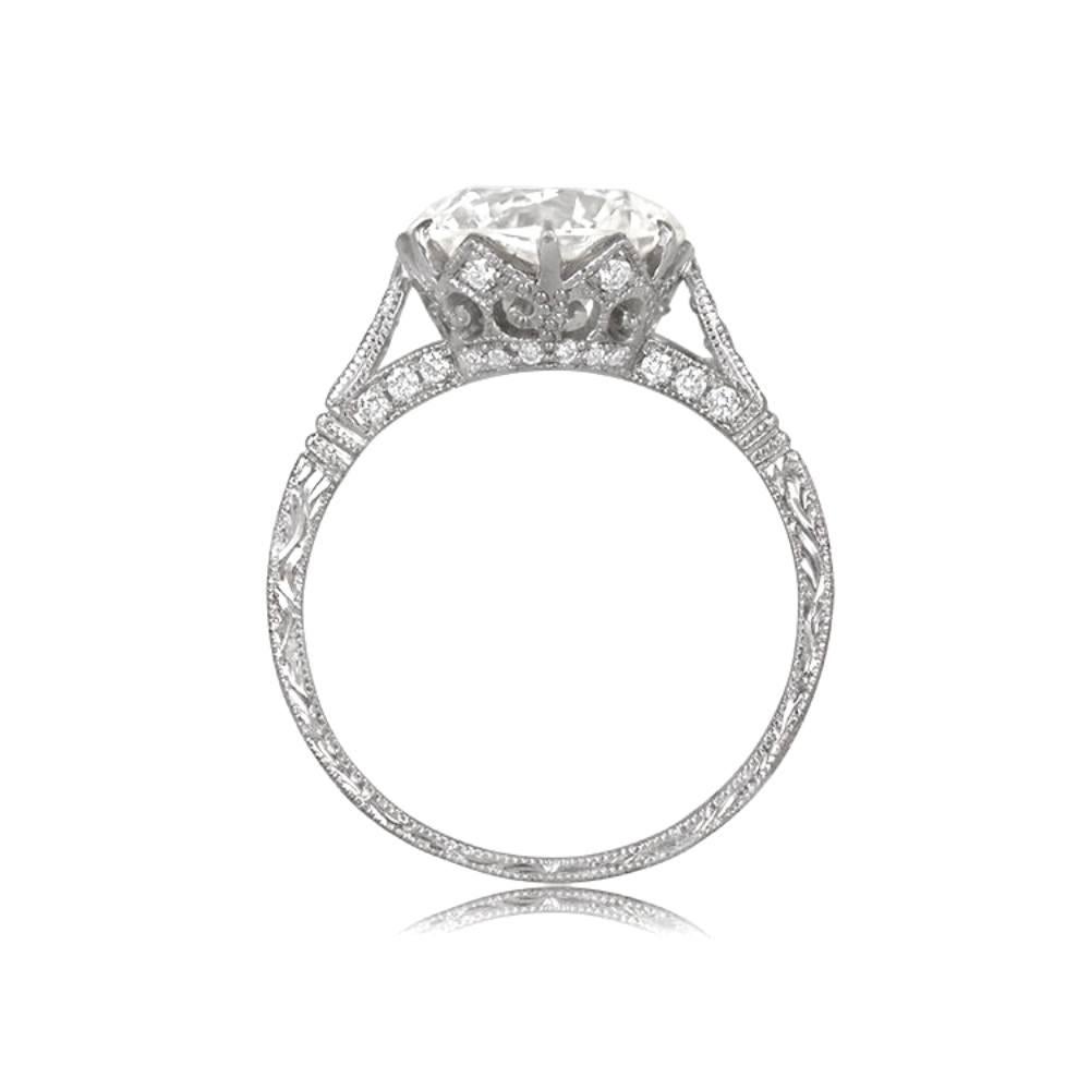 This handcrafted platinum solitaire engagement ring features a stunning 3.14-carat round transitional cut diamond, circa 1950. The L color and VS1 clarity of the center diamond add to its classic elegance. The ring also boasts diamond accents and
