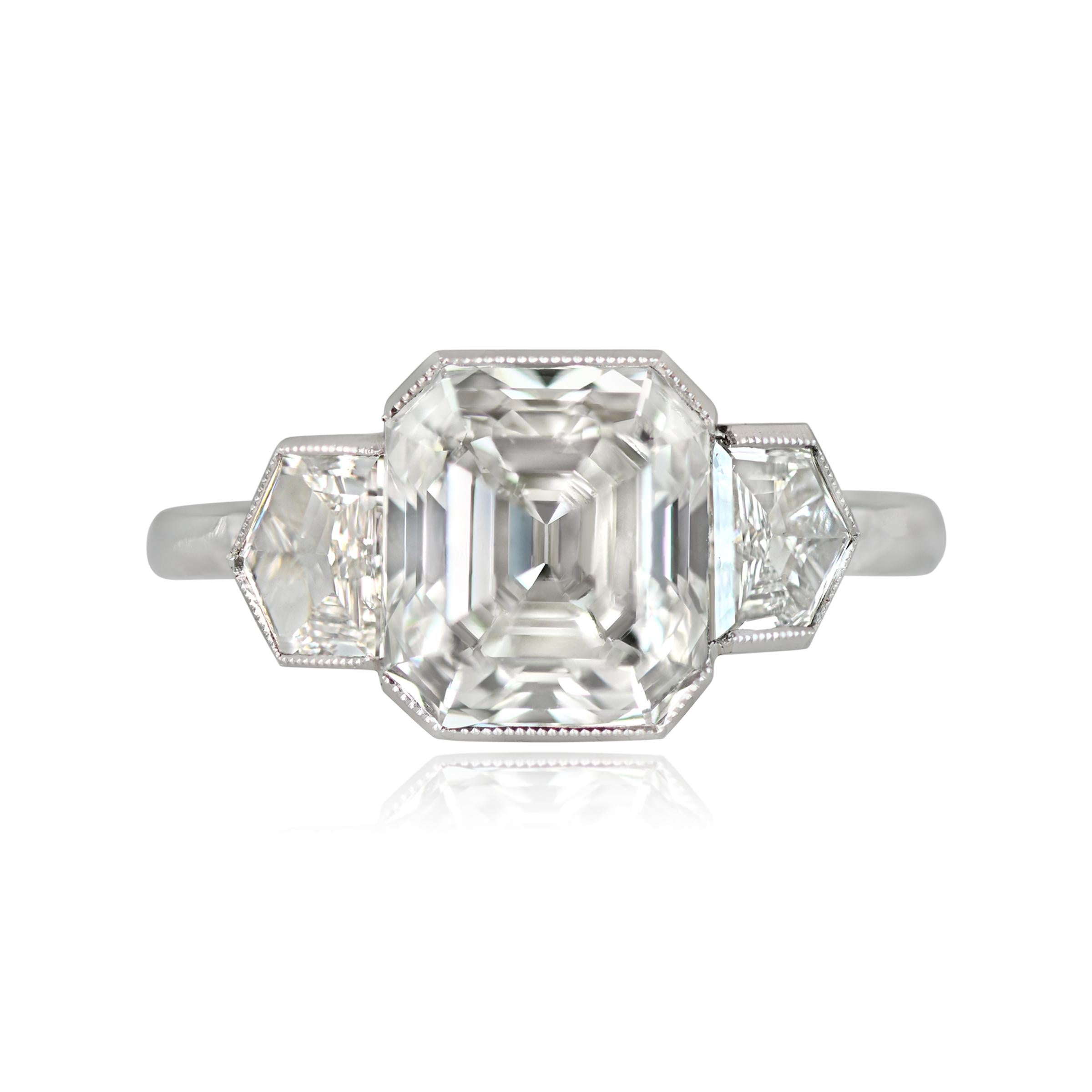 This is a stunning engagement ring showcases a 3.14-carat emerald-cut diamond (I color, VS2 clarity) in a half-bezel setting, flanked by two bullet-shaped diamonds weighing a total of 0.80 carats. Handcrafted in platinum.

Ring Size: 6.5 US,
