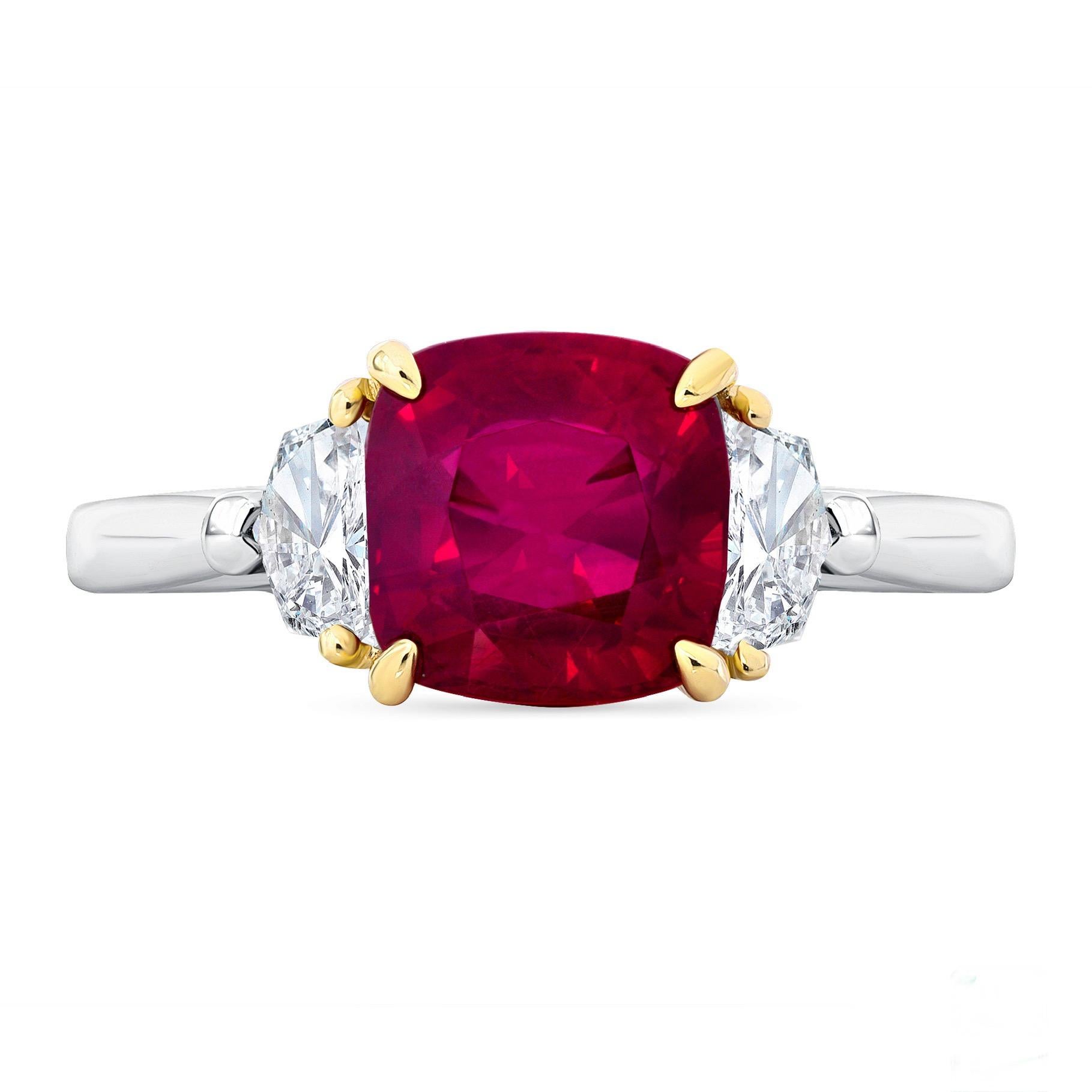 A 3.14-carat cushion-cut, untreated Mozambique Ruby is flanked by cadillac-cut diamonds weighing 0.34 carats, fabricated in platinum with 18K yellow gold. This scarce ruby is accompanied by a GIA report.