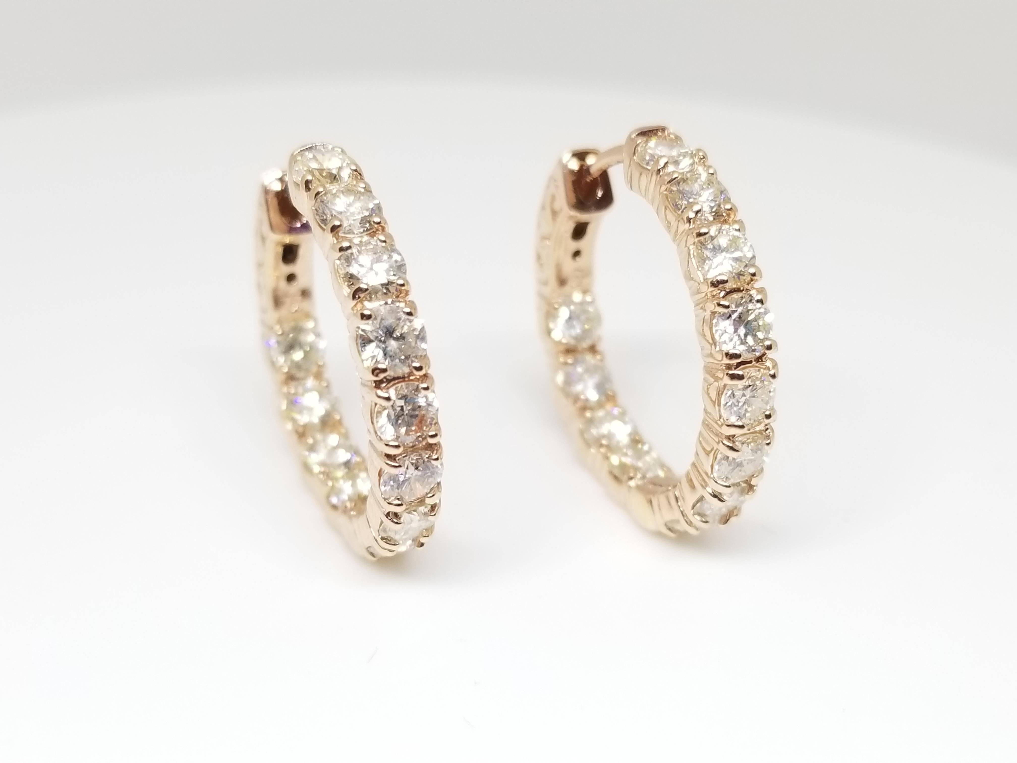 Beautiful pair of huggie diamond inside out hoop earrings available in 14k rose gold. Secures with snap closure for wear.  Measures 3/4 inch or 2mm in diameter. Beautiful stock for the holiday!