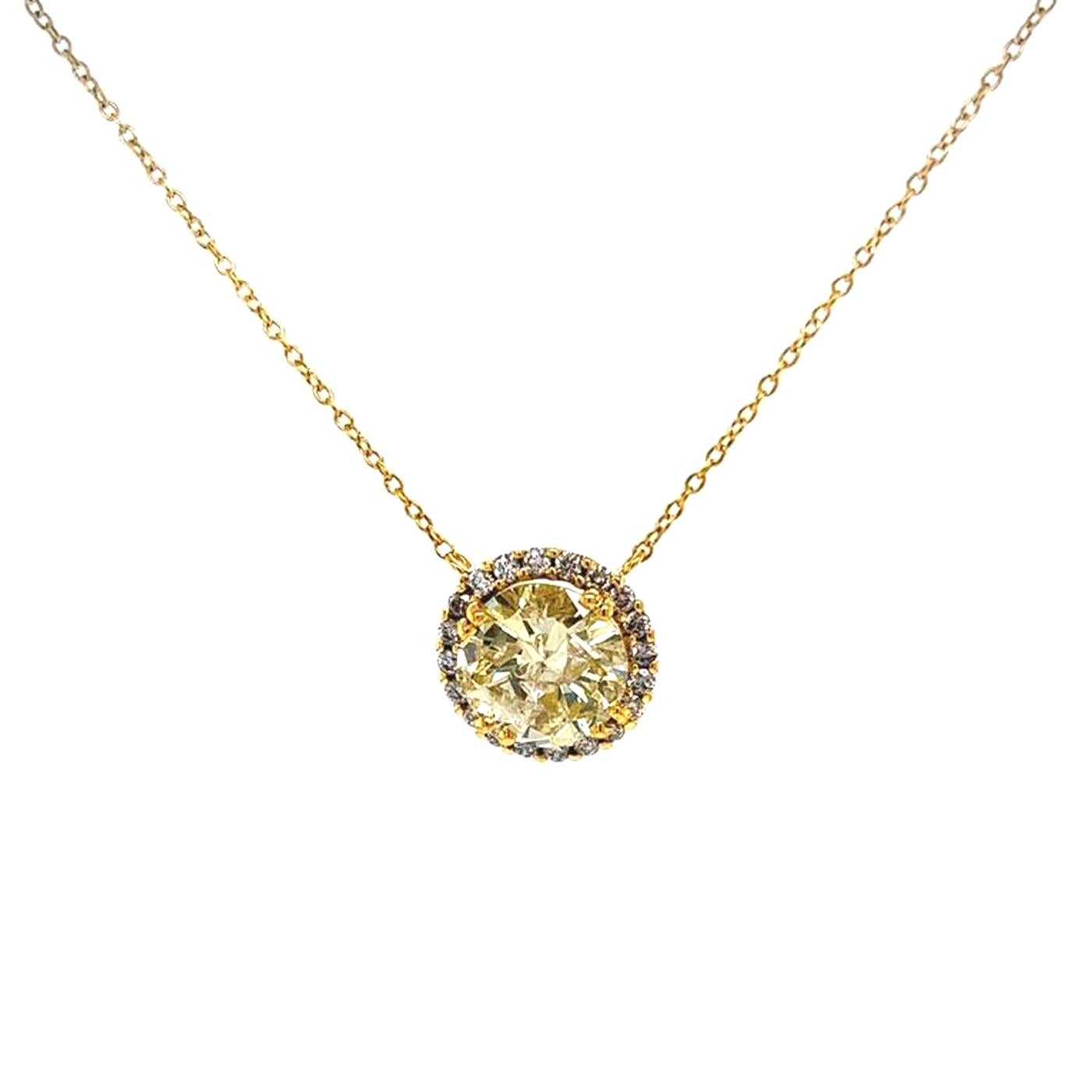 Beautiful 3.15 carat fancy round natural yellow diamond with eye-clean I1 clarity, bezel set in a halo of round brilliant diamonds. Accent diamonds are micro-pave sets and weigh 0.71 carats in total. made in 18 Karat gold on an 18-inch gold chain