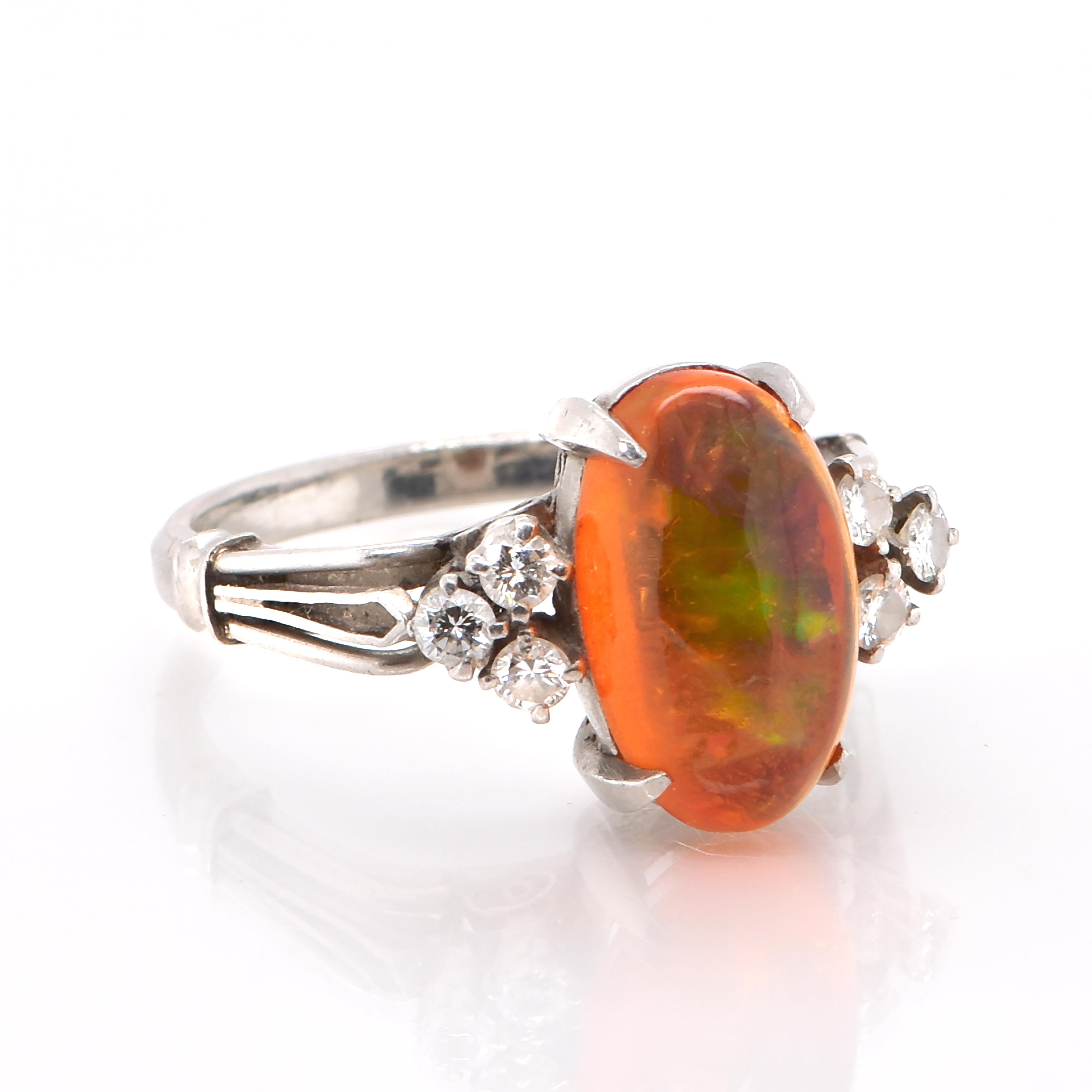 A beautiful ring featuring a 3.15 Carat Natural Mexican Fire Opal and 0.22 Carats of Diamond Accents set in Platinum. Opals are known for exhibiting flashes of rainbow colors known as 