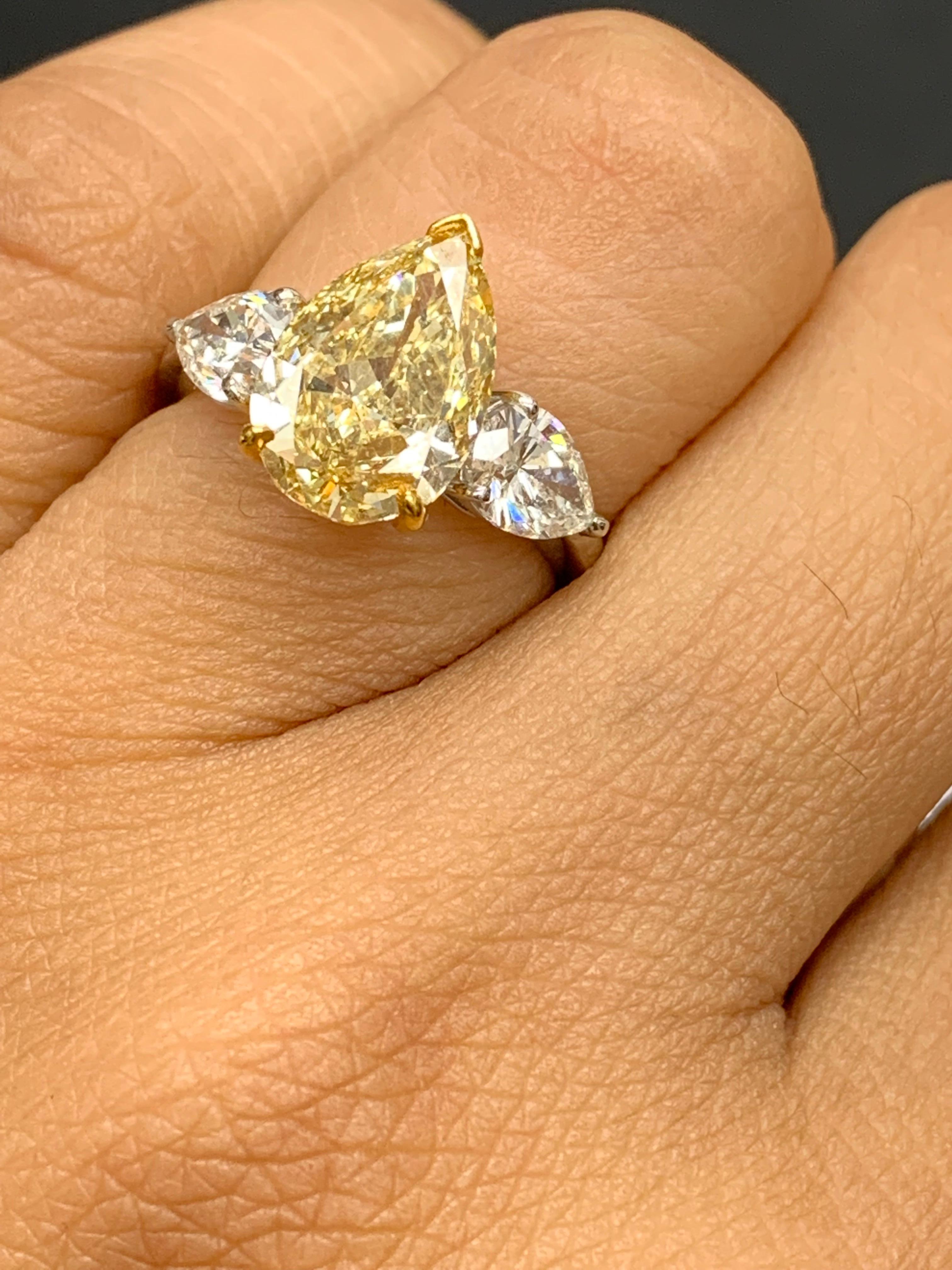3.15 Carat Pear Shape Fancy Yellow Diamond 3 Stone Ring in Platinum For Sale 3