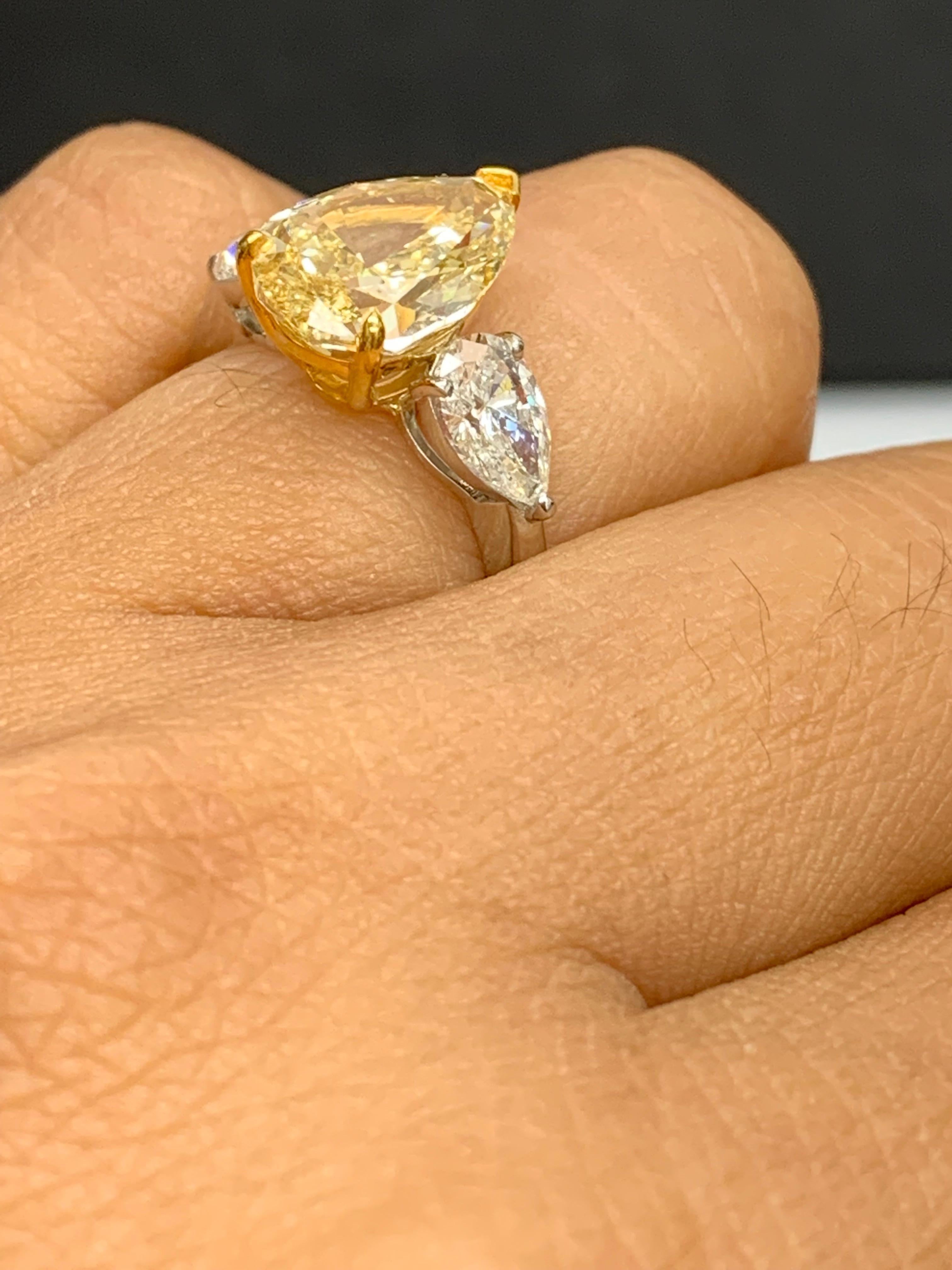 3.15 Carat Pear Shape Fancy Yellow Diamond 3 Stone Ring in Platinum For Sale 4