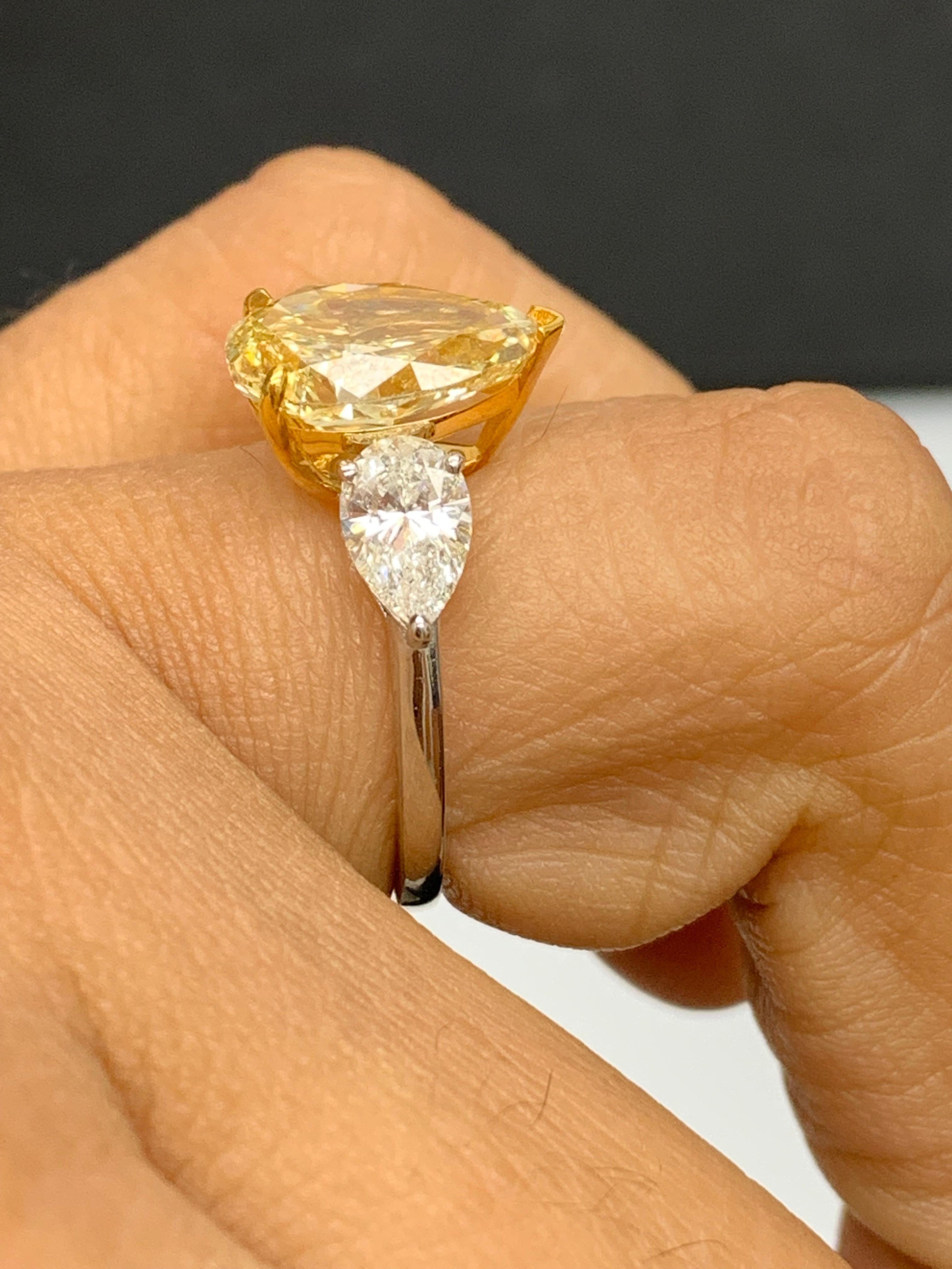 3.15 Carat Pear Shape Fancy Yellow Diamond 3 Stone Ring in Platinum For Sale 6