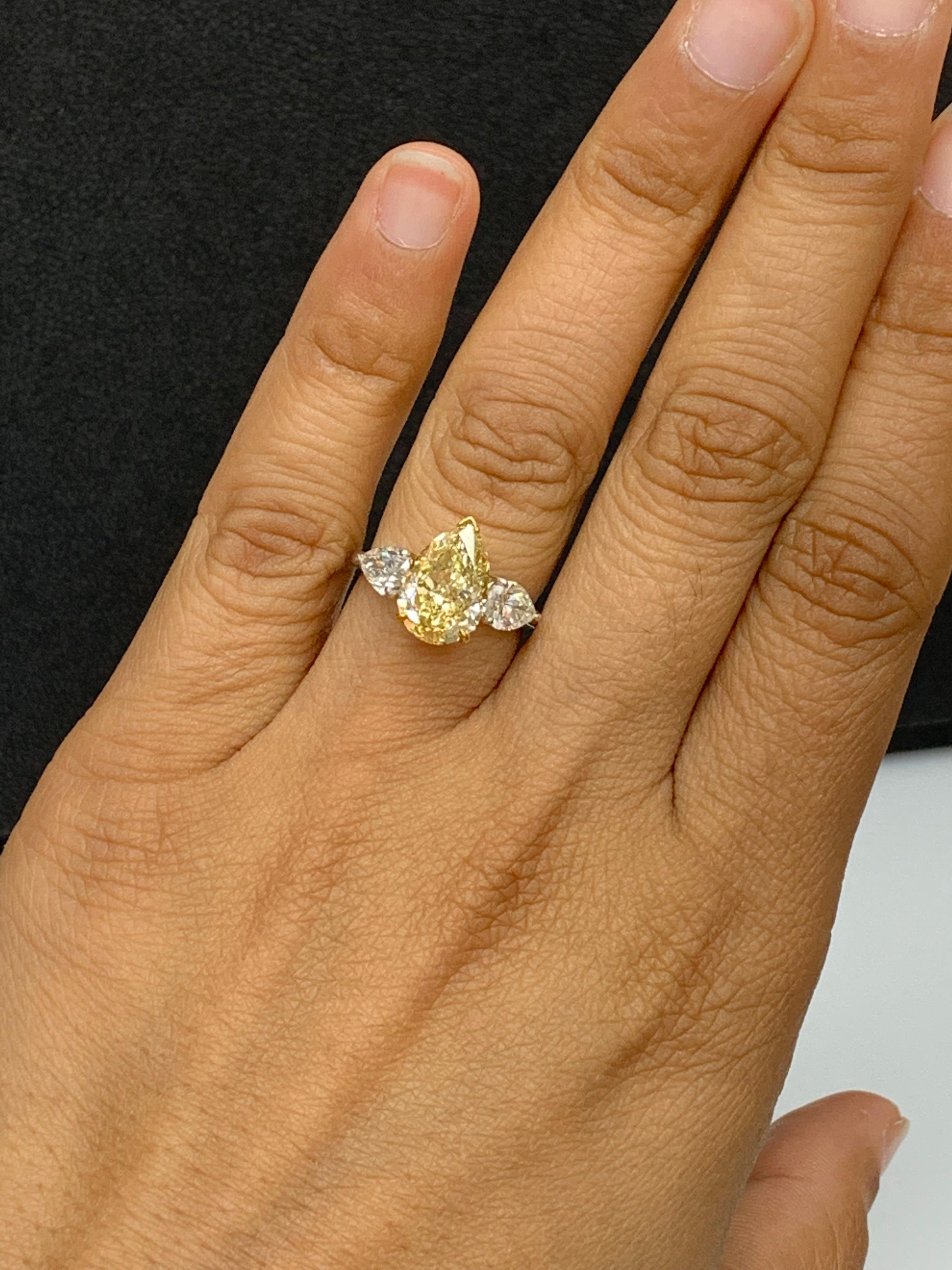 Pear Cut 3.15 Carat Pear Shape Fancy Yellow Diamond 3 Stone Ring in Platinum For Sale