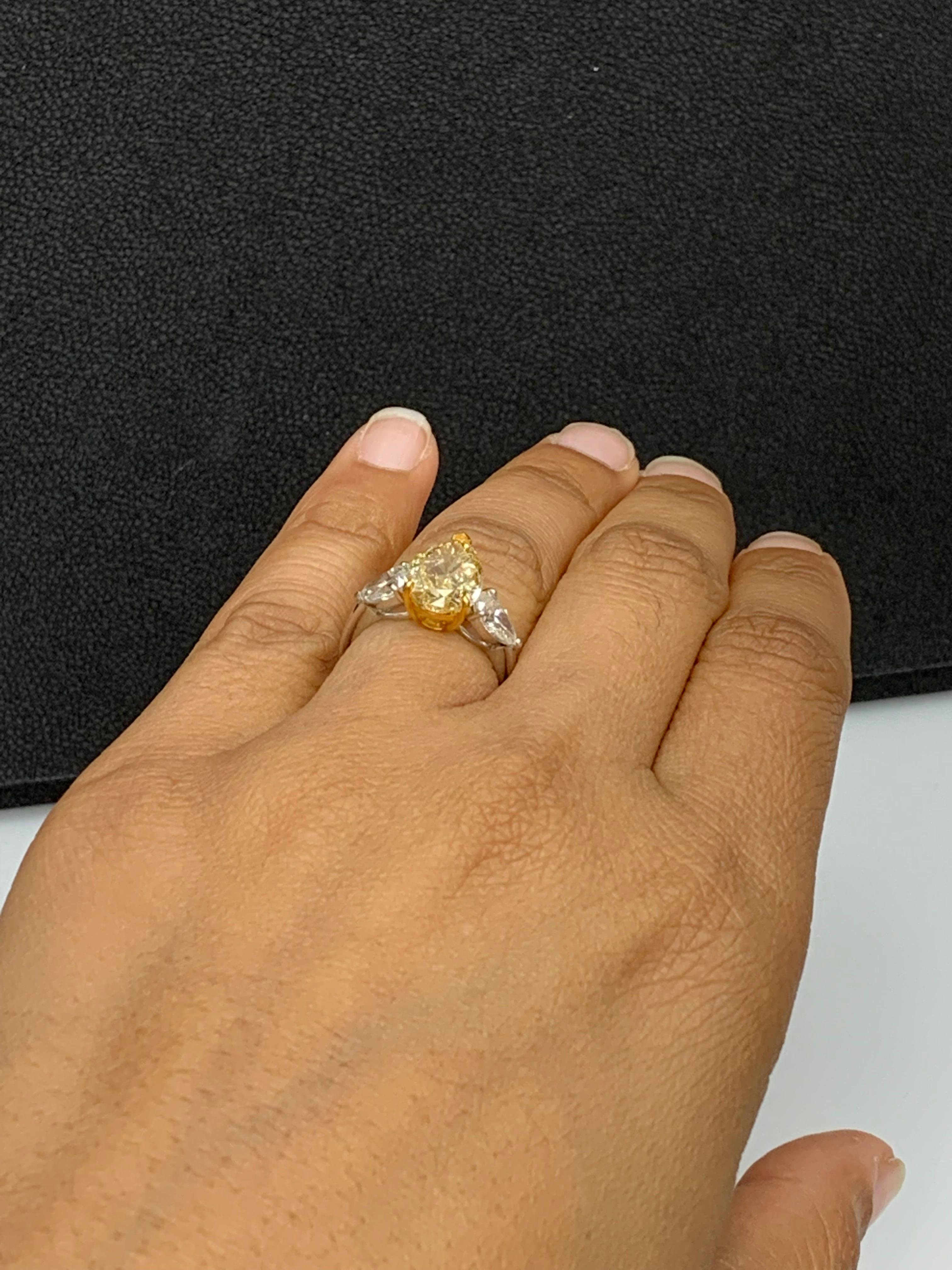 3.15 Carat Pear Shape Fancy Yellow Diamond 3 Stone Ring in Platinum In New Condition For Sale In NEW YORK, NY