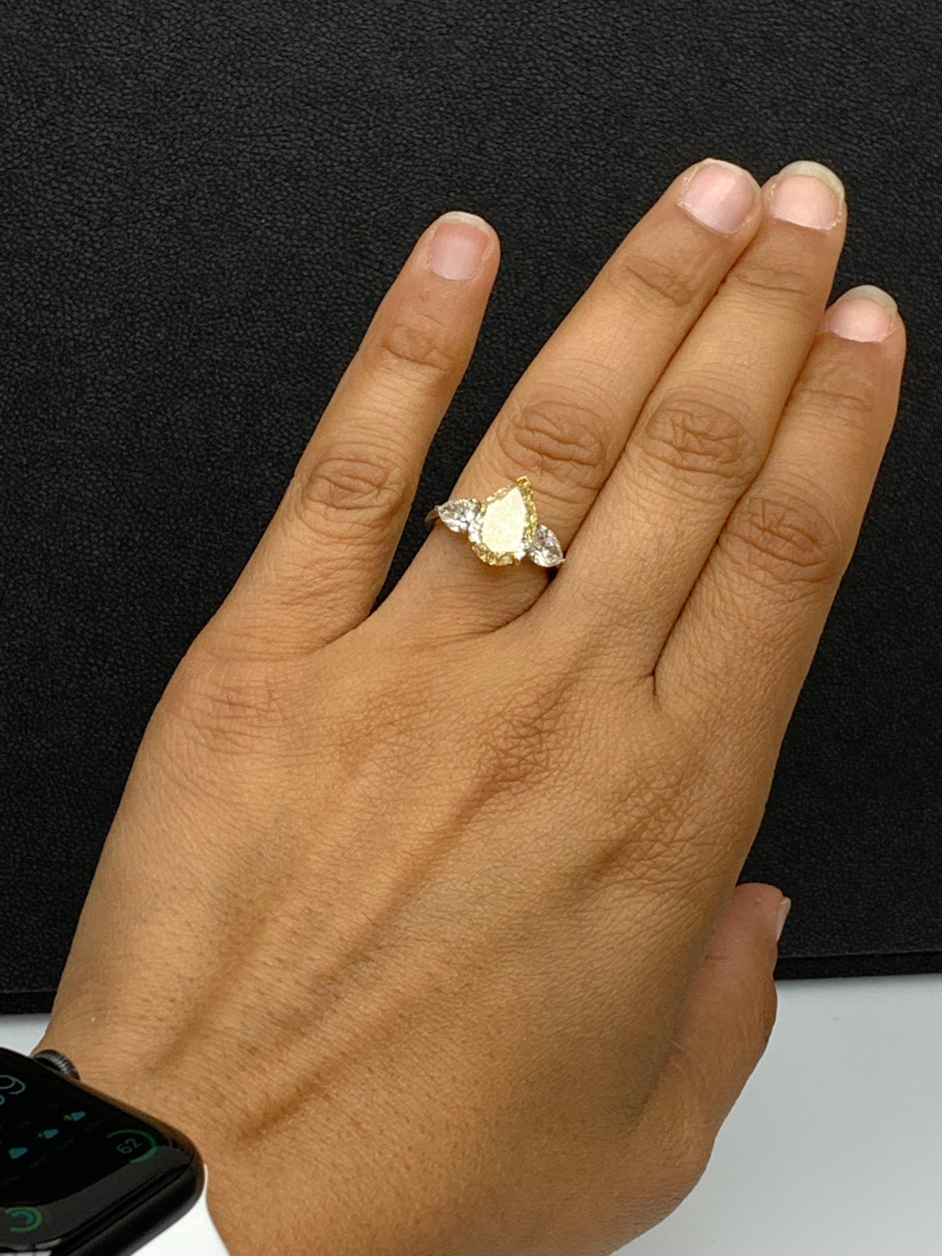 Women's 3.15 Carat Pear Shape Fancy Yellow Diamond 3 Stone Ring in Platinum For Sale