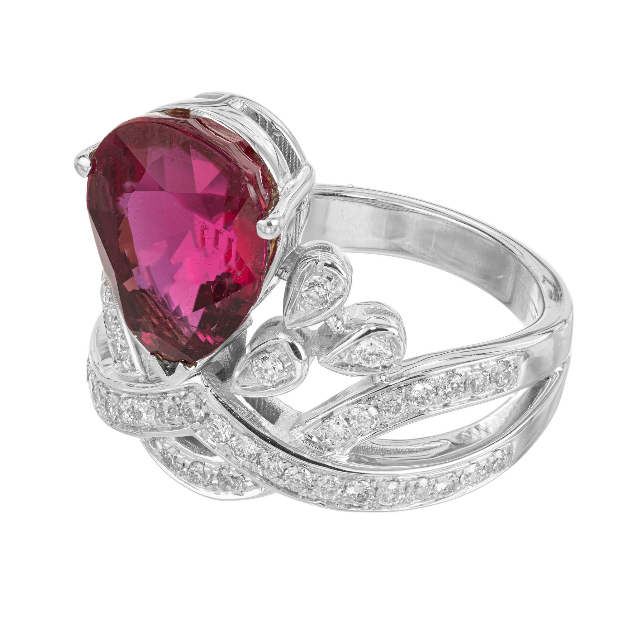 Bright reddish pink pear shaped tourmaline and diamond tiara style cocktail ring. This ring begins with a dazzling 3.15 carat deep, rich, pear shaped tourmaline. Mounted in a crown style 18k white gold setting which is adorned by 46 round brilliant