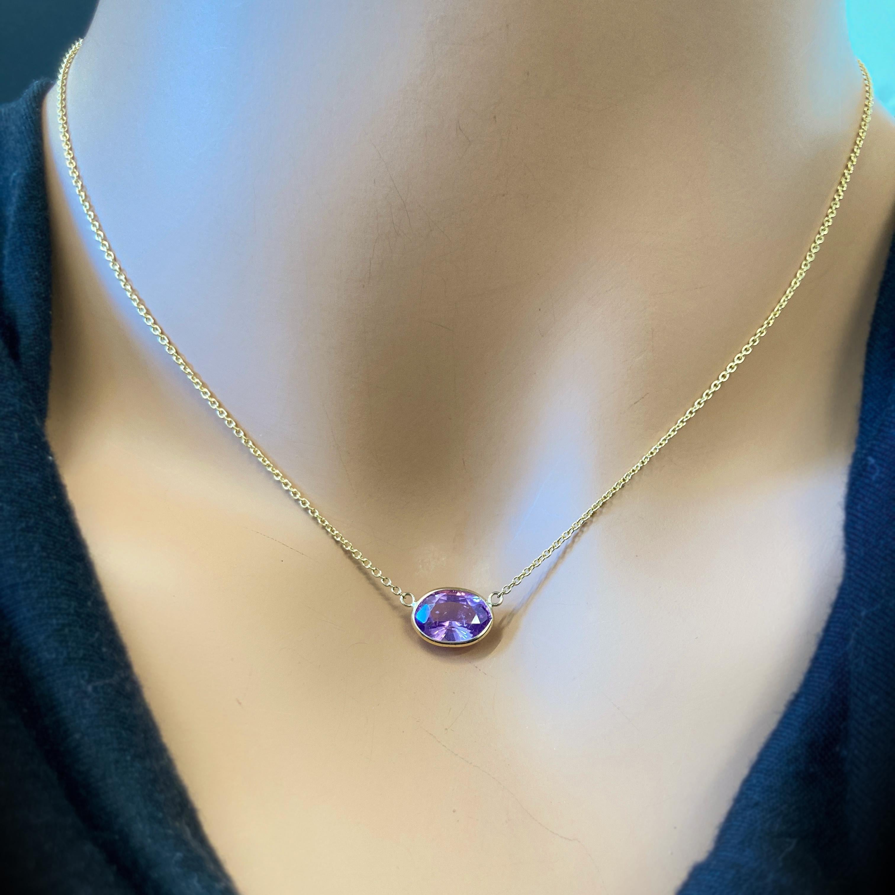This necklace features an oval-cut purple sapphire with a weight of 3.15 carats, set in 14k yellow gold (YG). Purple sapphires are valued for their lovely purple hue, and the oval cut is a classic and elegant choice for gemstones, offering a