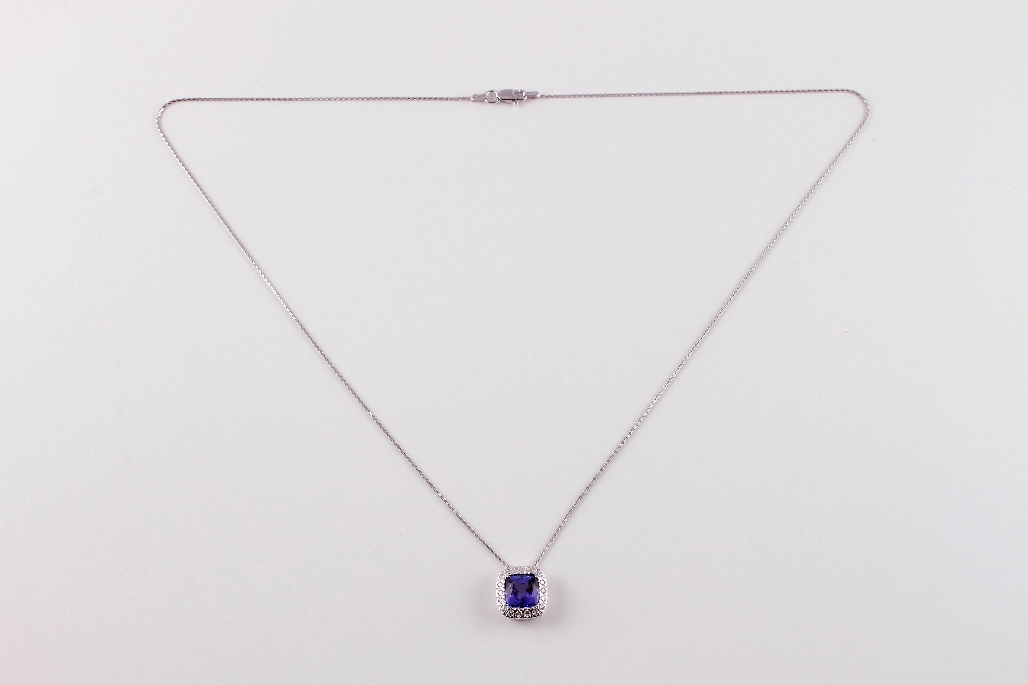 This lovely 3.15 carat tanzanite is surrounded by 0.28 carats of diamonds and is suspended from a 20 inch, white gold chain with a lobster clasp.