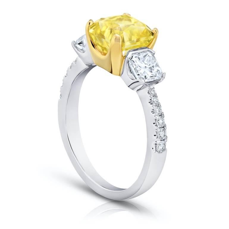 3.15 carat radiant cut yellow ceylon (no heat) sapphire with two radiant cut  (F+ VS+) weighing 1.01 carats and  twelve round diamonds weighing .14 carats set in a platinum and 18k yellow gold ring.
