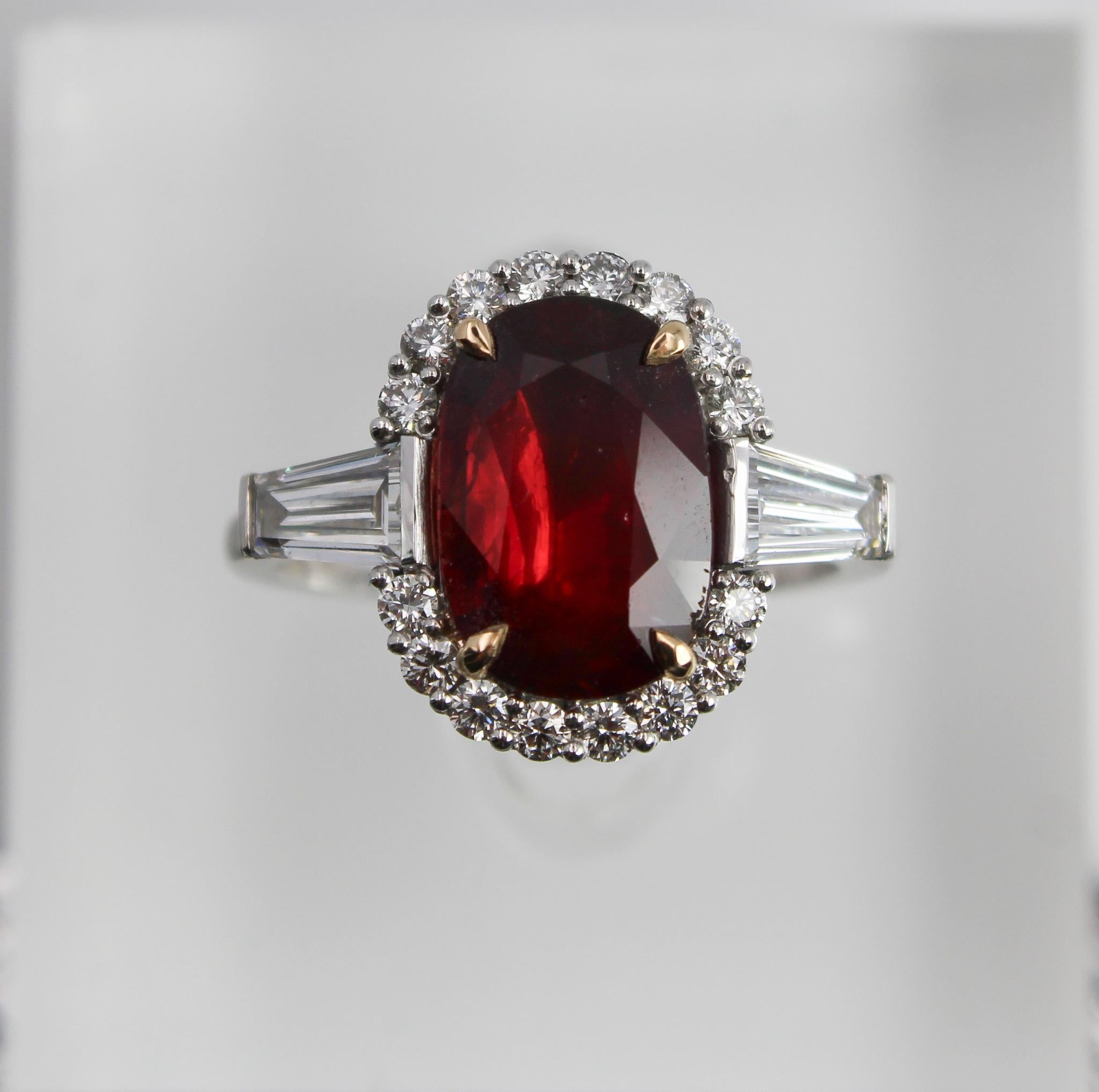 This exceptional ring features a vivid 3.15 carat natural ruby from Mozambique, certified by GRS with no indications of thermal treatment. The ruby displays an intense red hue and is beautifully cut in an oval shape, measuring approximately 11.64 x