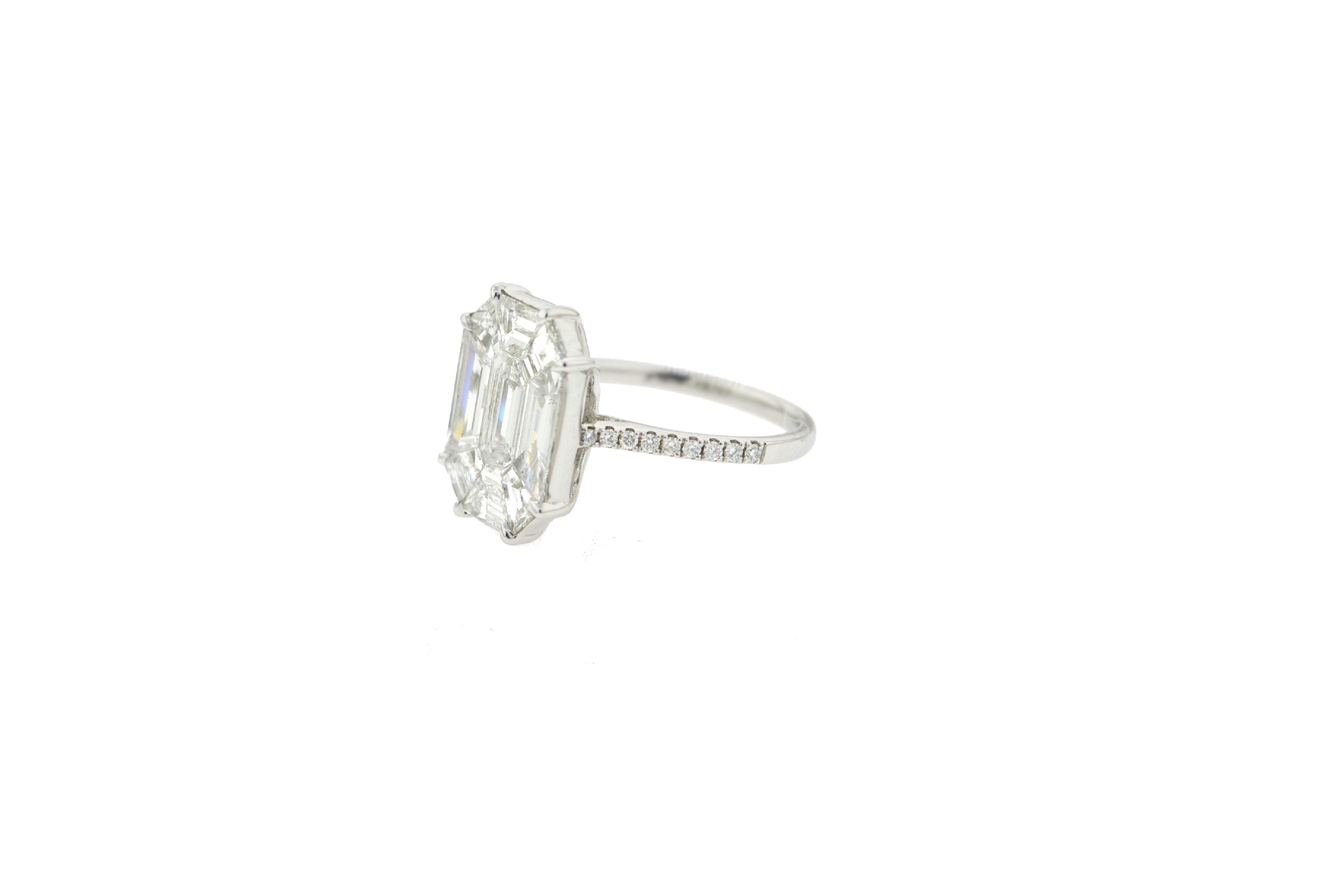 JR 3.16 Carat Emerald Cut Illusion Diamond Ring 18 Karat White Gold

Emerald, Baguette and Trapezoid shaped diamonds set in an illusion to create the look of a 9 carat single emerald cut stone. The ring is set in 18 Karat white gold. The color of