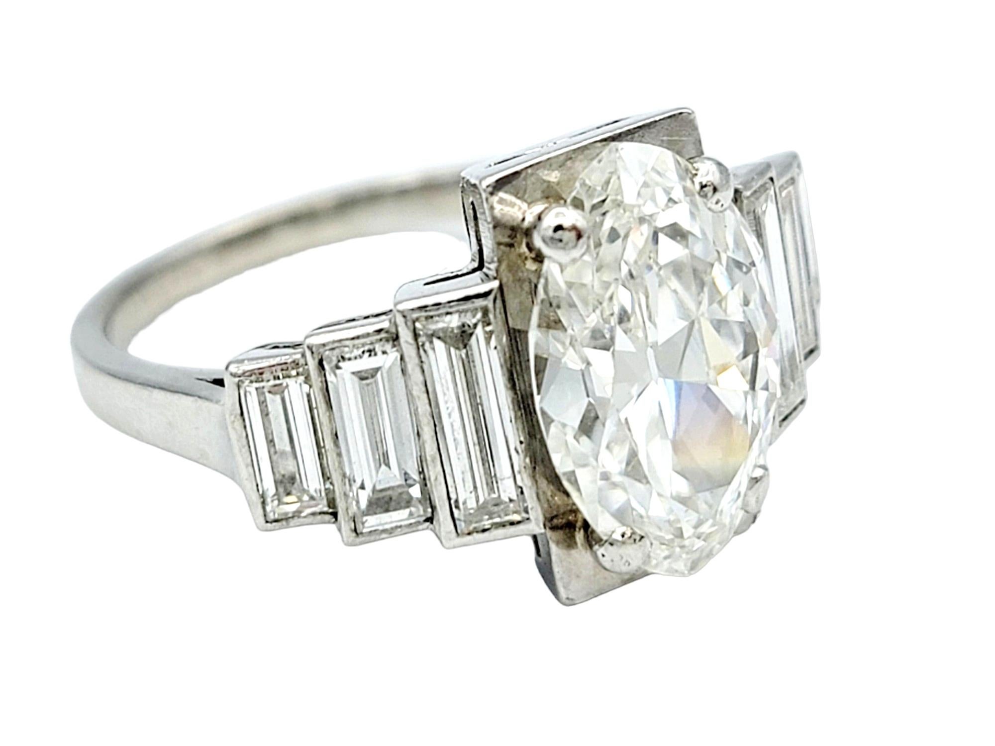 Ring Size: 6.5

This incredible Art Deco platinum and diamond ring is a radiant embodiment of timeless glamour and sophistication. At its center, a dazzling 2.5 carat marquise-cut diamond takes the spotlight, showcasing its brilliant sparkle and