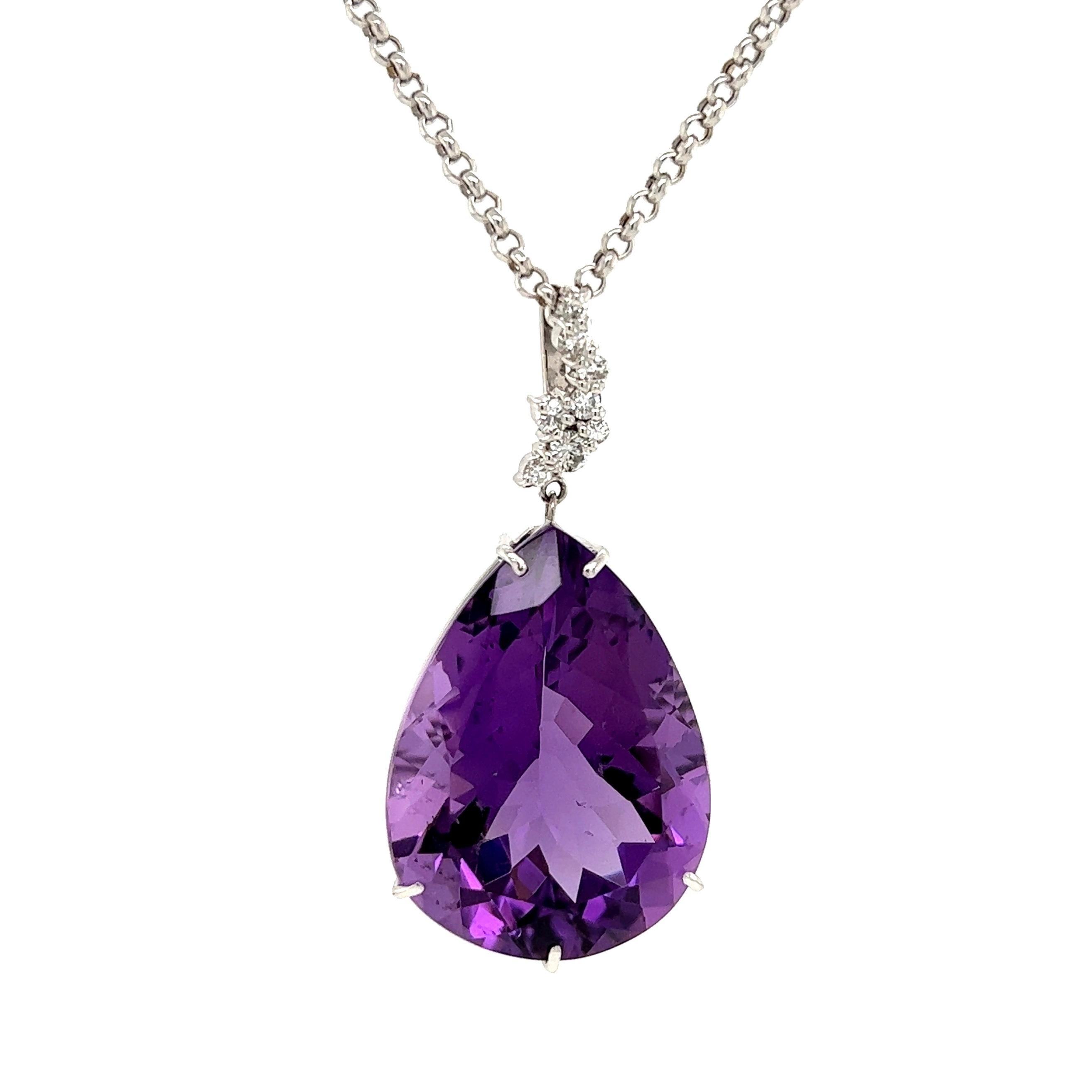 Simply Beautiful! Amethyst and Diamond Gold Drop Pendant Necklace. Center securely Hand set with a 31.63 Carat Pear Shape Amethyst, surrounded by Diamonds approx. 0.23tcw. Suspended from a Gold Link Chain, approx. 18” long. Pendant dimensions: 1.60”