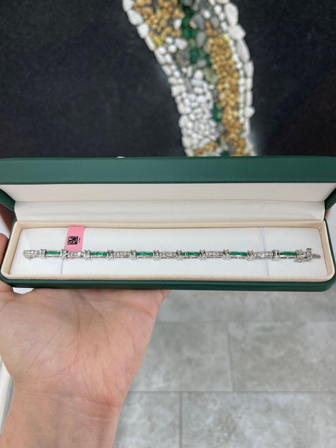 A dapper natural emerald and diamond bracelet. This stunning piece features numerous natural emerald cut emeralds that are channel set and display a medium-dark green color, with very good luster and clarity. In between, each one of its emerald