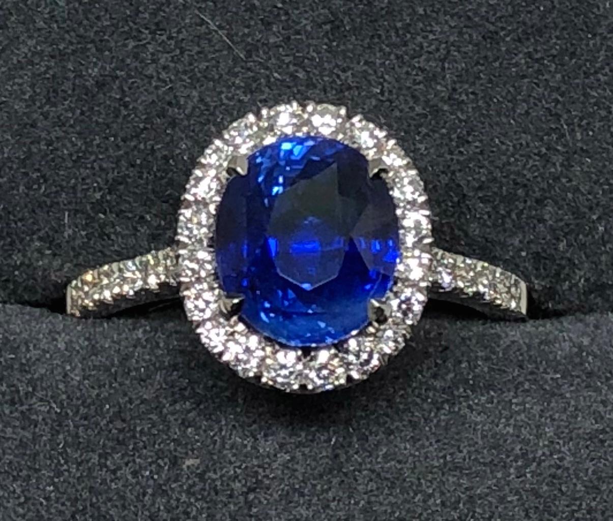Modern 3.17 carat Blue Sapphire and  Halo Cluster Diamond ring in Platinum