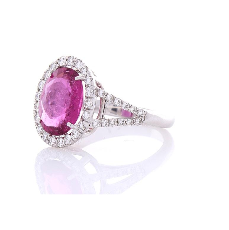 This intense reddish-pink gemstone ring is a captivating sight to behold! The ring features a lively oval cut 3.17 carat – 9.45 x 7.78 millimeter vivid rubellite that exhibits radiant pink, purple, red, and gorgeous light reflections. This gem is