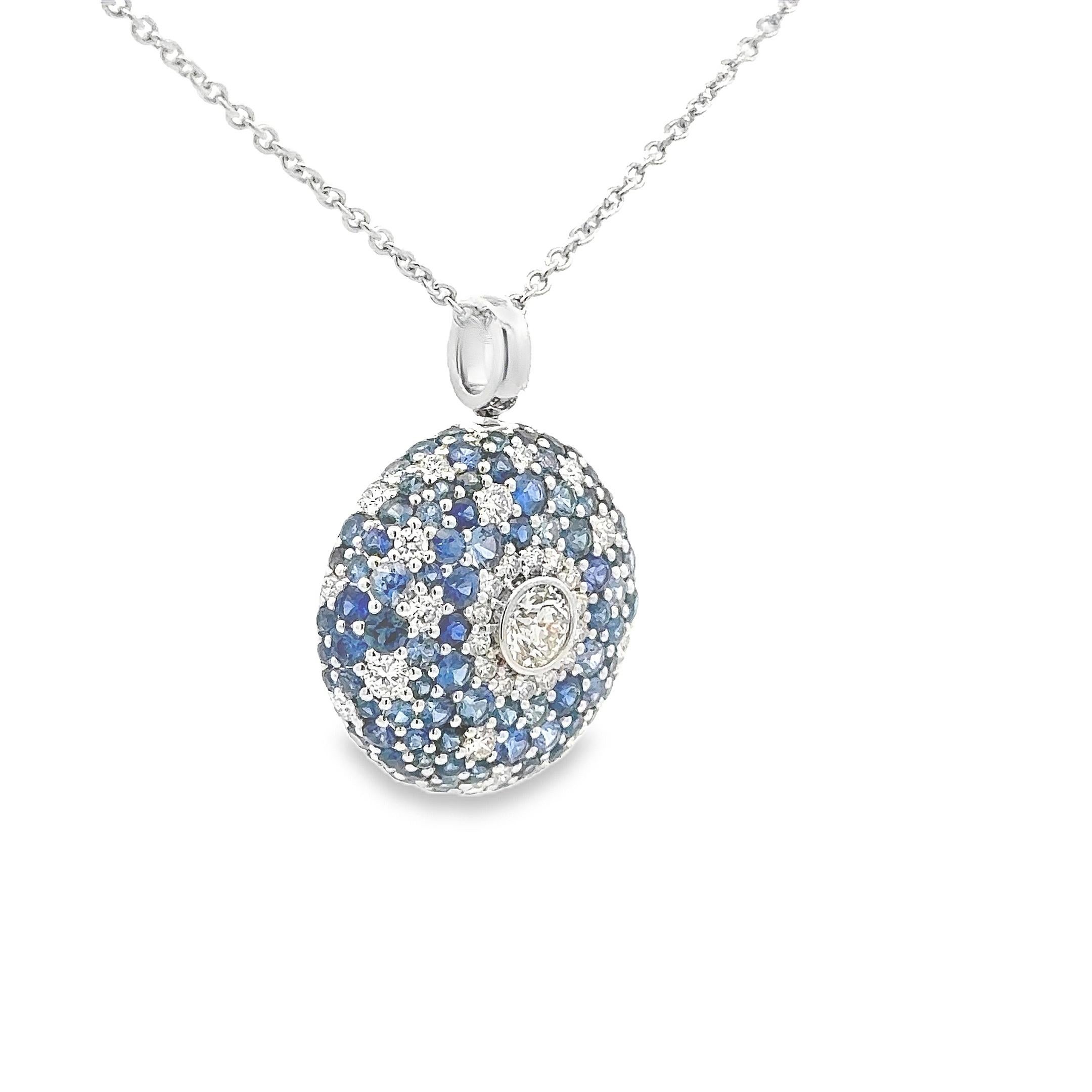 Una collana pendente alla moda, con diamanti taglio rotondo per un peso totale di 0,79 carati e il diamante più grande incastonato al centro. Accentuato da zaffiri blu taglio rotondo per un peso totale di 2,38 carati. Le pietre più piccole sono